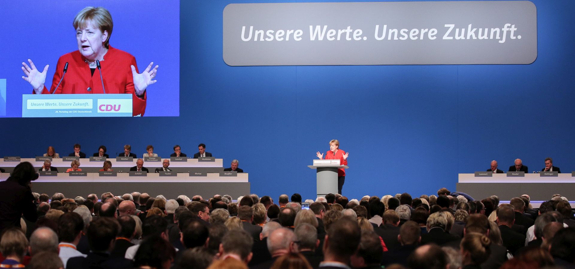 epa05662169 CDU leader and German Chancellor Angela Merkel speaks at the CDU federal party conference in Essen, Germany, 06 December 2016. The insscription above the podium reads; 'Our values. Our future'.  EPA/OLIVER BERG