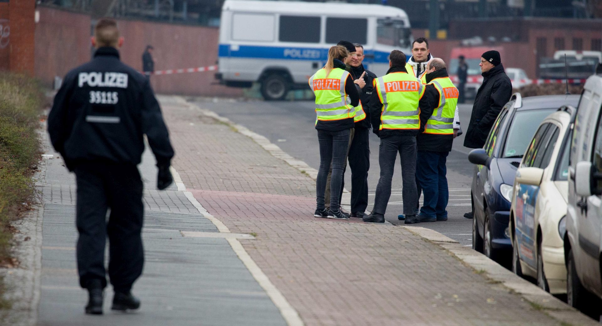 epa05684330 German police officers gather for further investigation at the area in which the truck used in the 19 December Berlin Christmas Market attack is believed to have been parked last, at the Friedrich-Krause-Ufer in an industrial area in the western harbor in Berlin, Germany, 21 December 2016. At least 12 people were killed and around 50 injured in the evening of 19 December 2016, when a truck was driven into a Christmas market, in what authorities said was a deliberate attack.  EPA/KAY NIETFELD