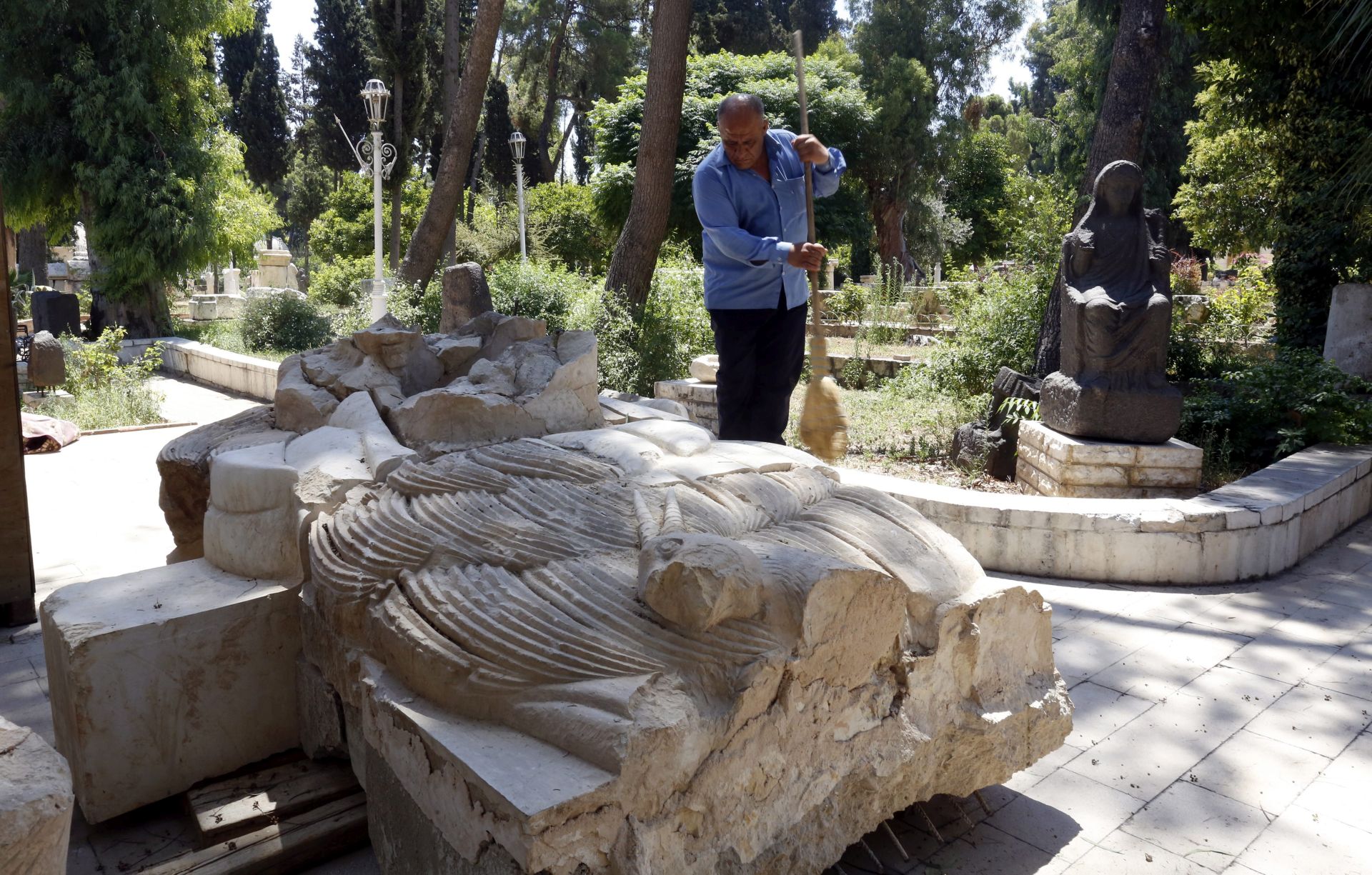 epa05438854 Worker at the National Museum in Damascus cleans the remains of the lion of al-Lat, an 2,000-year-old statue that was destroyed by the Islamic State's militants in the central ancient city of Palmyra in 2015, Damascus, Syria, 24 July 2016. The statue was brought to the National Museum in Damascus for renovation. A Polish mission is expected in Damascus to do the renovation works. The limestone statue was discovered in 1977 by a Polish archaeological mission at the temple of al-Lat, a pre-Islamic Arabian goddess, and dated back to the 1st century BC.  EPA/YOUSSEF BADAWI