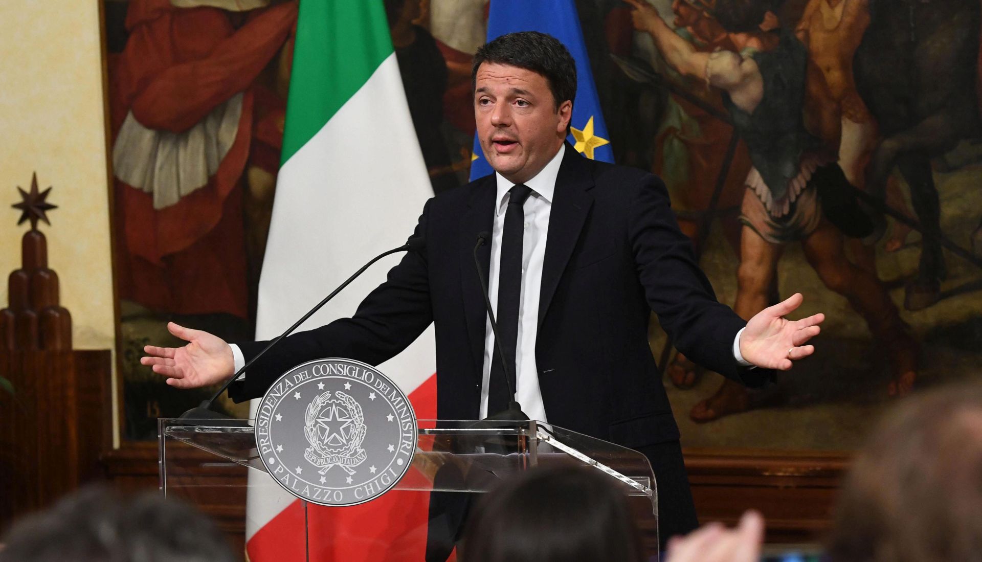 epa05660305 talian Prime Minister Matteo Renzi during a press conference in Rome, Italy, 04 December 2016 after the referendum on constitutional reform, with his wife Angese Landini in the background. Matteo Renzi has announced his resignation after exit polls on 04 December 2016 suggest a 'No' vote victory in a crucial referendum to which Renzi had tied his political future. The referendum is considered by the government to end gridlock and make passing legislation cheaper by, among other things, turning the Senate into a leaner body made up of regional representatives with fewer lawmaking powers. It would also do away with the equal powers between the Upper and Lower Houses of parliament - an unusual system that has been blamed for decades of political gridlock.  EPA/ALESSANDRO DI MEO