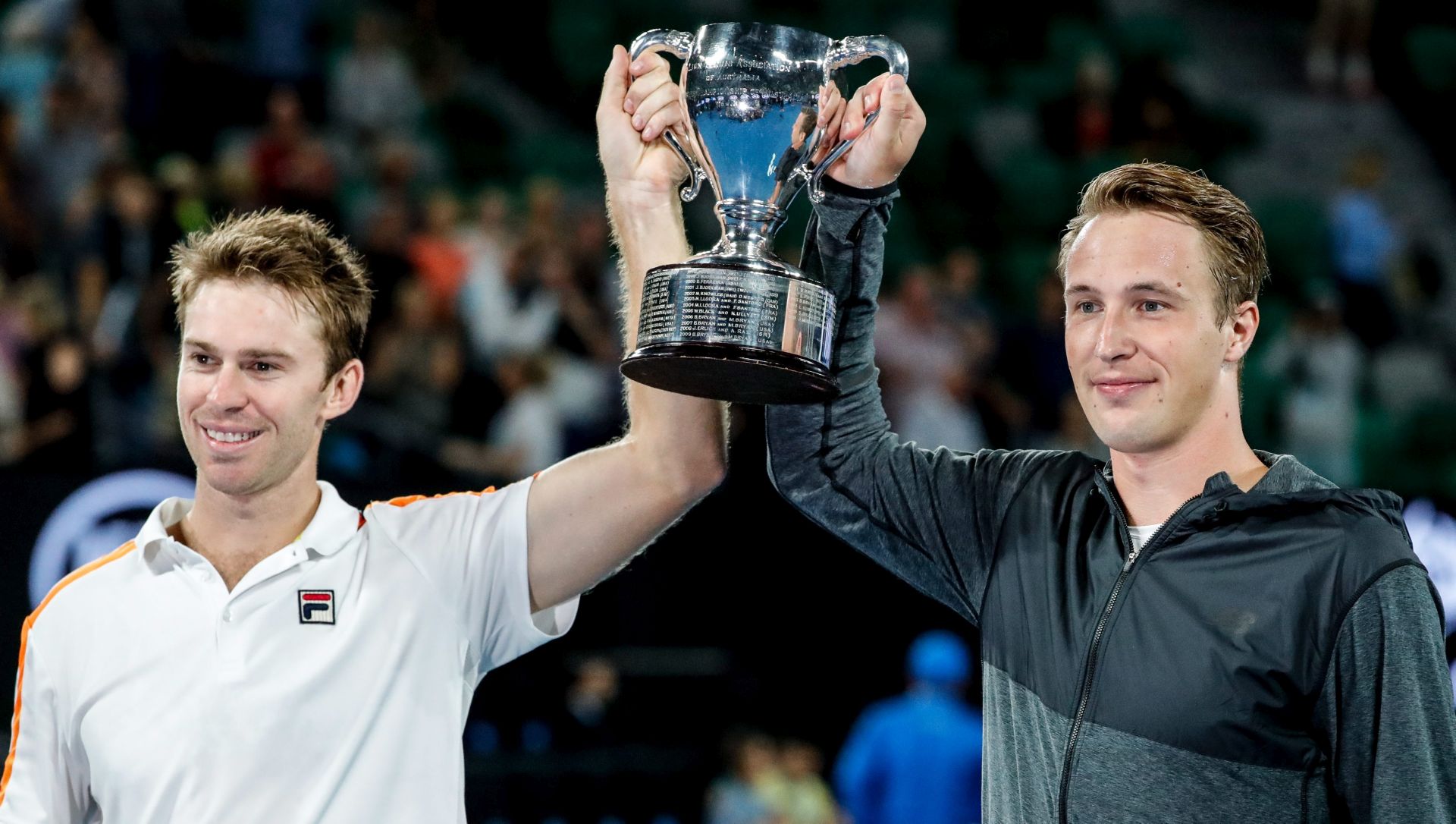 epa05756593 Finland's Henri Kontinen (R) and Australia's John Peers lift  the trophy after defeating Bob Bryan and Mike Bryan of theUnited States in the  Men's Doubles final at the Australian Open Grand Slam tennis tournament in Melbourne, Victoria, Australia, 28 January 2017.  EPA/MADE NAGI