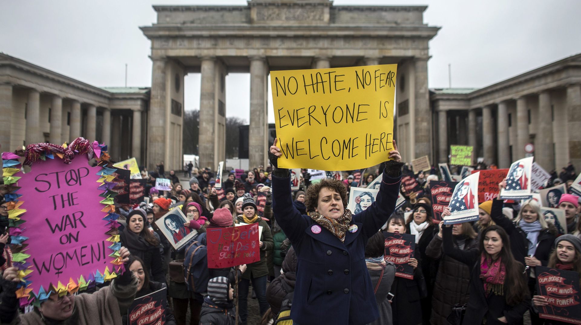 epa05738213 People protest in front of the Brandenburg Gate in Berlin, Germany, 21 January 2017. Dozens of protestors demanded equal rights for women. Hundreds of rallies are due to take place in over 30 countries around the world following the inauguration of US President Donald Trump.  EPA/OLIVER WEIKEN