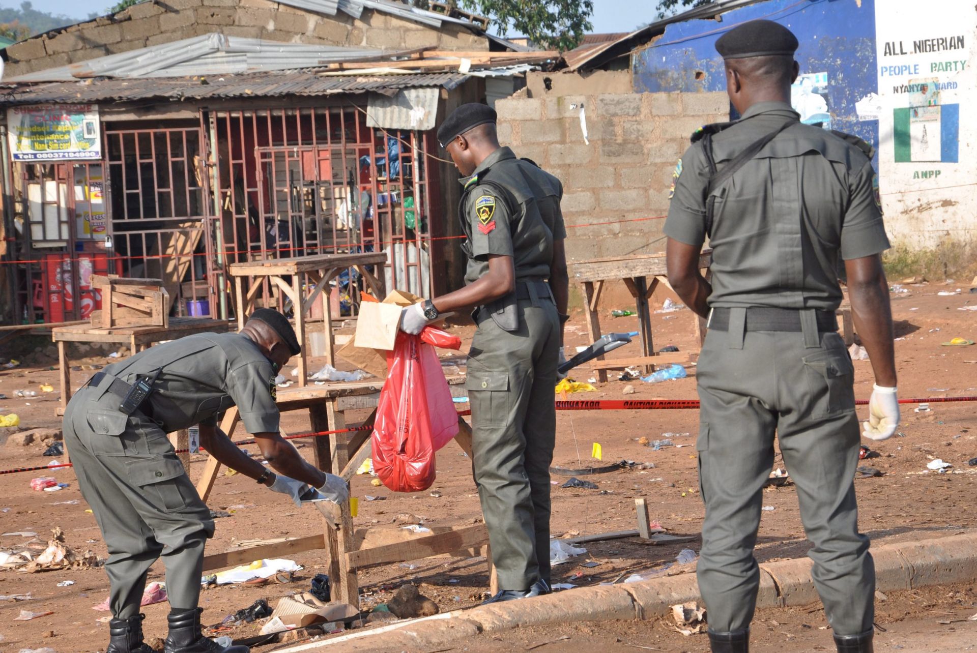 epa04961613 A photograph made avaiable on 03 October 2015 showing Nigeria security personnel searching the scene of Nyanya bomb blast in Abuja, Nigeria, 02 October 2015. Multiple explosions that rocked the outskirts of Nigeria's federal capital Abuja on Friday night have left at least 15 people dead, an official involved in the rescue operations said.  EPA/STRINGER