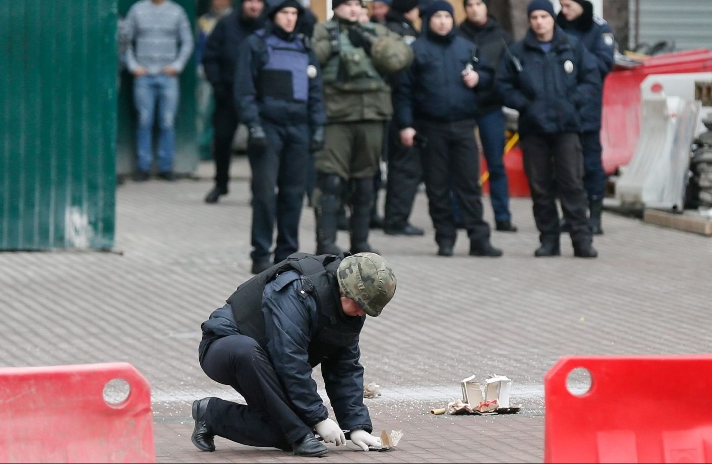 epa05641004 Ukrainian policeman investigates the suspected explosive object near of Kiev’s City hall in Kiev, Ukraine, 21 November 2016. A man, who left probable dangerous objects, was arrested by police. Ukrainians mark the third anniversary of the Euromaidan Revolution in Ukraine. On 21 November 2013 activists started an anti-government picket after then-Prime Minister Mykola Azarov announced the suspension of a landmark treaty with the European Union. The protests eventually led to the ouster of President Viktor Yanukovych, creating political rifts through the country that erupted into violent conflict between seperatists and government forces in the eastern part of the country in the spring.  EPA/SERGEY DOLZHENKO