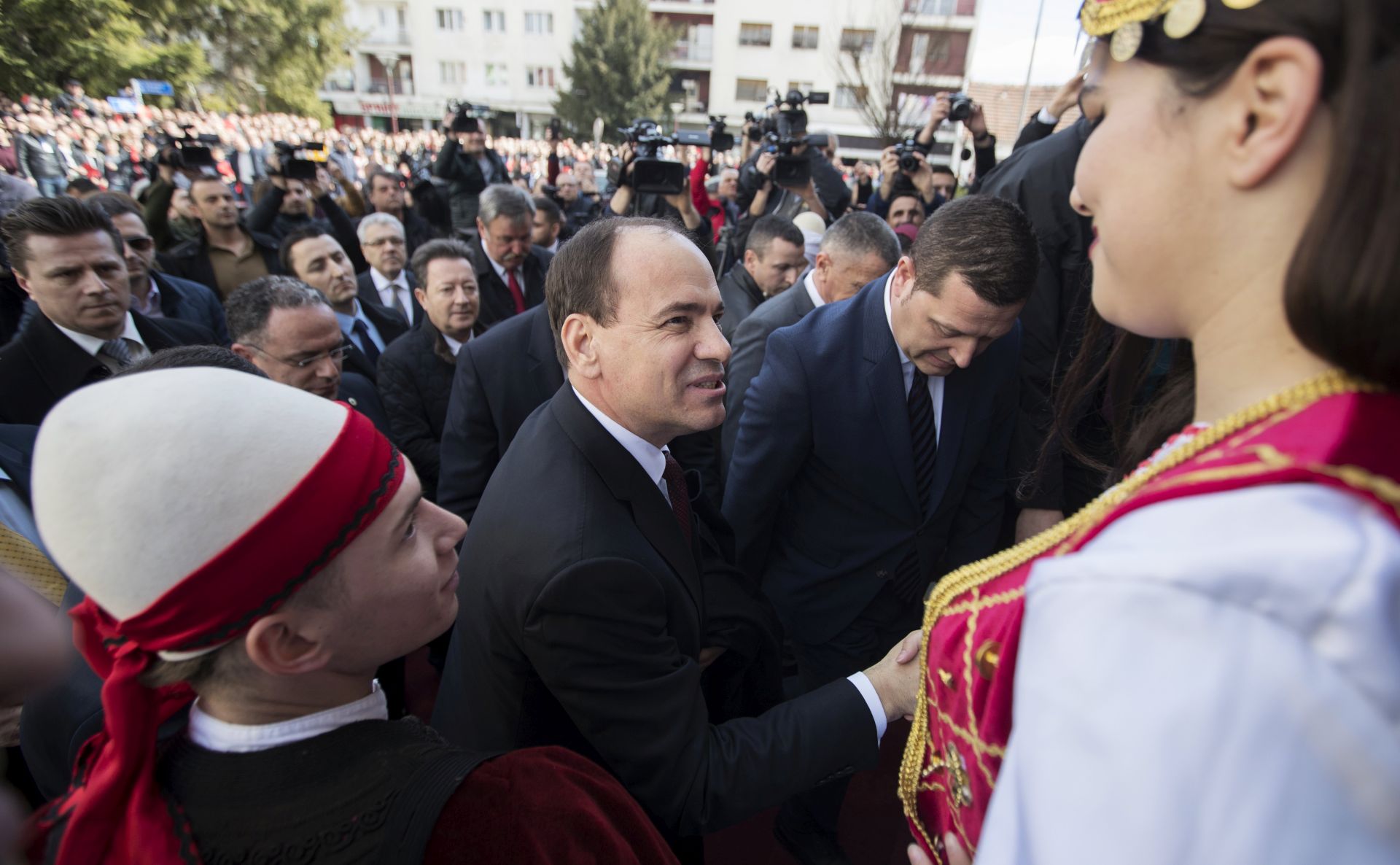 epa05834379 President of the Republic of Albania Bujar Nishani (C) greets local Albanians during his visit in the town of Bujanovac, Serbia, 07 March 2017. This is the first visit of an Albanian President to Serbia in 69 years. Albania's first president to visit Serbia was late dictator Enver Hoxha in 1948. President Bujar Nishani is visiting the Presevo Valley on the occasion of marking the 130th anniversary of the first Albanian School and Teachers Day.  EPA/VALDRIN XHEMAJ