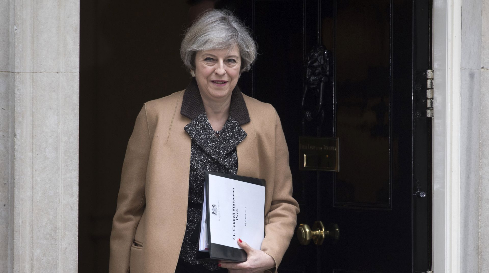 epa05847321 British Prime Minister Theresa May leaves 10 Downing Street to deliver a statement to the House of Commons in London, Britain, 14 March 2017. The Governments bill triggering Brexit passed the The House of Lords on 13 March 2017 allowing British Prime Minister Theresa May to start the process of the United Kingdom leaving the European Union.  EPA/WILL OLIVER