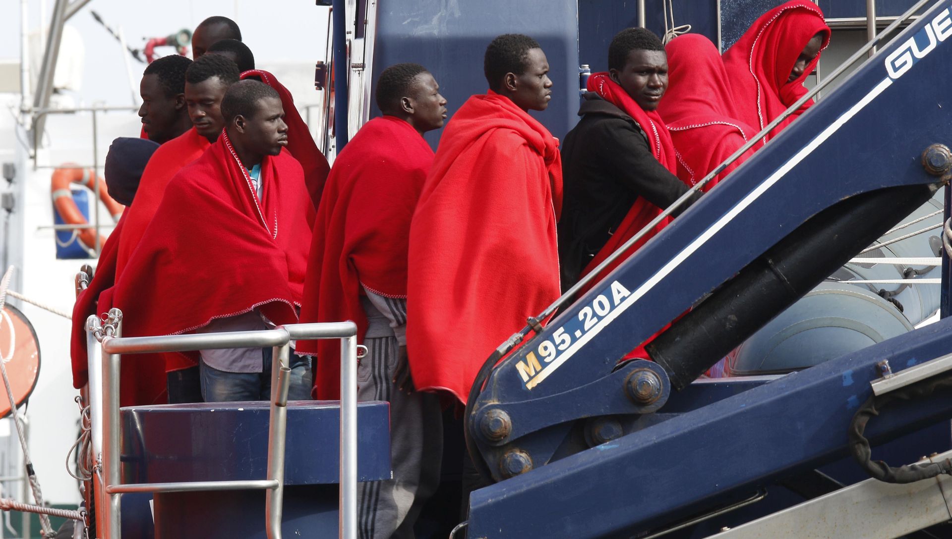 epa05860410 Some of the 32 migrants that have been rescued by Spanish Nary Rescue members arrive in the port of Almeria, Spain, 20 March 2017. A group of reportedly 32 migrants were rescued by the Spanish Navy when they travelled some 18 milles off the coast of the Alboran Island.  EPA/CARLOS BARBA