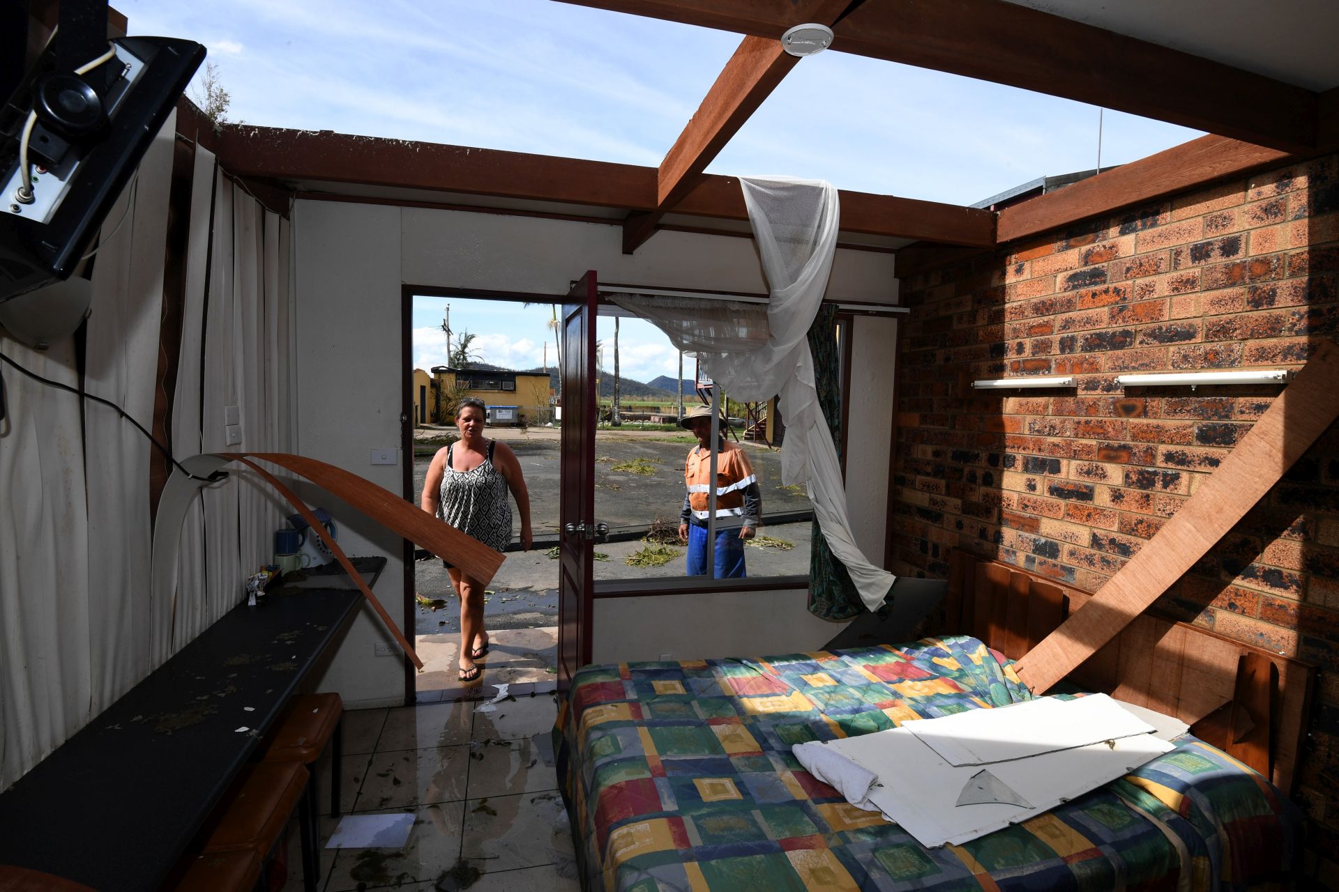 epa05878282 Kerry Campbell and Peter Stokes inspect damage to their motel in Proserpine, Queensland, Australia, 30 March 2017. Cyclone Debbie hit Queensland's north coast on 28 March as a category 4 cyclone, causing wide spread damage. A severe rain depression is currently taking place throughout south-east Queensland following ex-Tropical Cyclone Debbie.  EPA/DAN PELED  AUSTRALIA AND NEW ZEALAND OUT