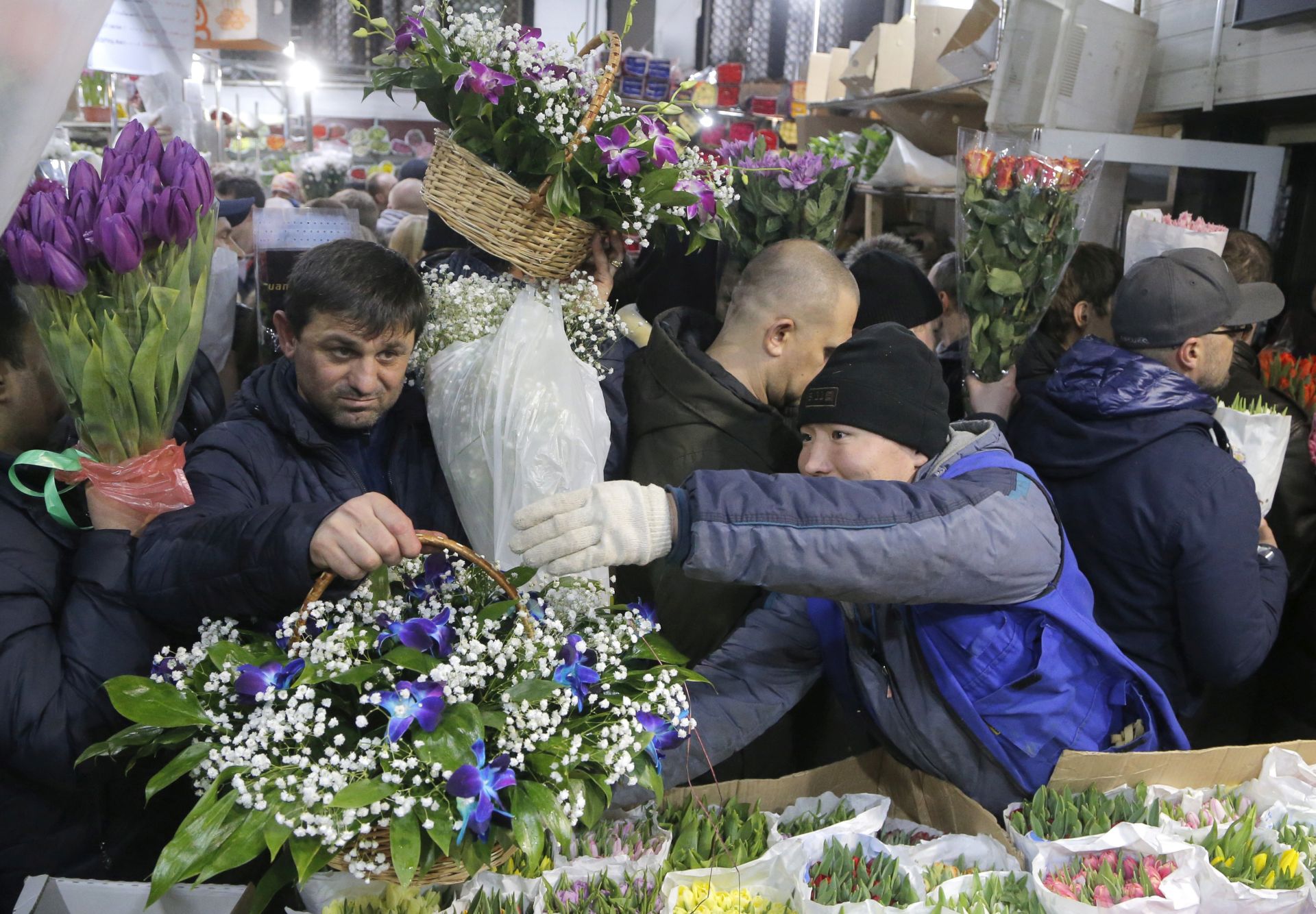 epaselect epa05834702 People attend the Rizhsky flower market on the eve of International Women's Day in downtown Moscow, Russia, 07 March 2017. International Women's Day is the one of the favorite holidays in Russia.  EPA/MAXIM SHIPENKOV
