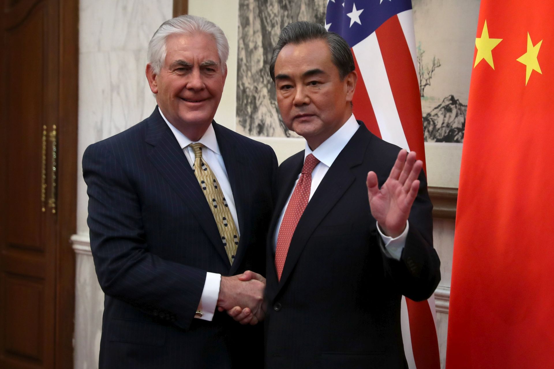 epa05855535 US Secretary of State Rex Tillerson (L) shakes hands with Chinese Foreign Minister Wang Yi (R) as he arrives for a bilateral meeting at the Diaoyutai State Guesthouse in Beijing, China, 18 March 2017. Tillerson is in China as part of his three-country trip through the Asia-Pacific region.  EPA/MARK SCHIEFELBEIN / POOL