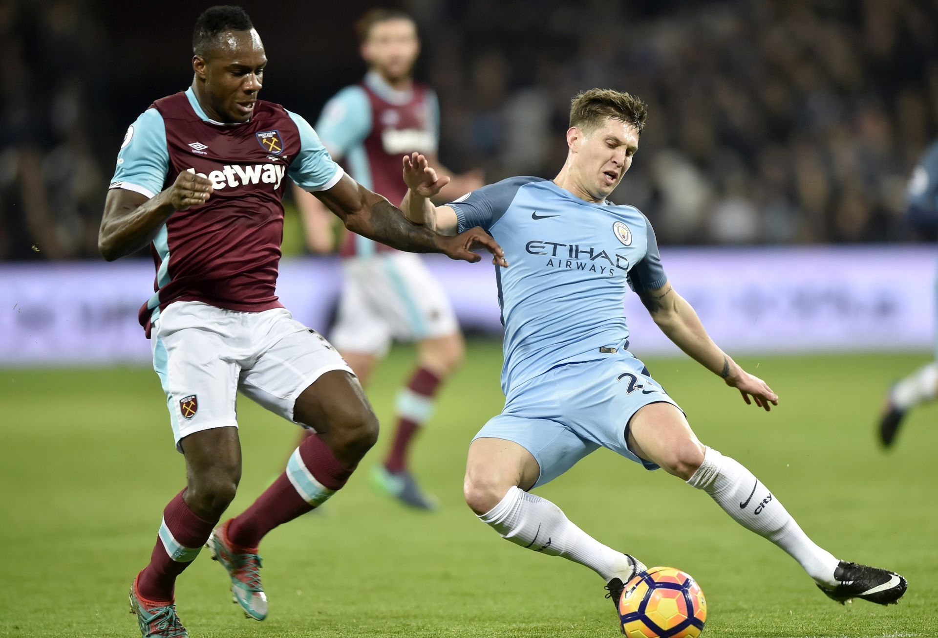 epa05765462 West Ham United's Michail Antonio (L) vies for the Ball with Manchester City's John Stones (R) during the English Premier League soccer match between West Ham and Manchester City at the London Stadium in London, Britain, 01 February 2017. 
EDITORIAL USE ONLY. No use with unauthorized audio, video, data, fixture lists, club/league logos or 'live' services. Online in-match use limited to 75 images, no video emulation. No use in betting, games or single club/league/player publications  EPA/HANNAH MCKAY
