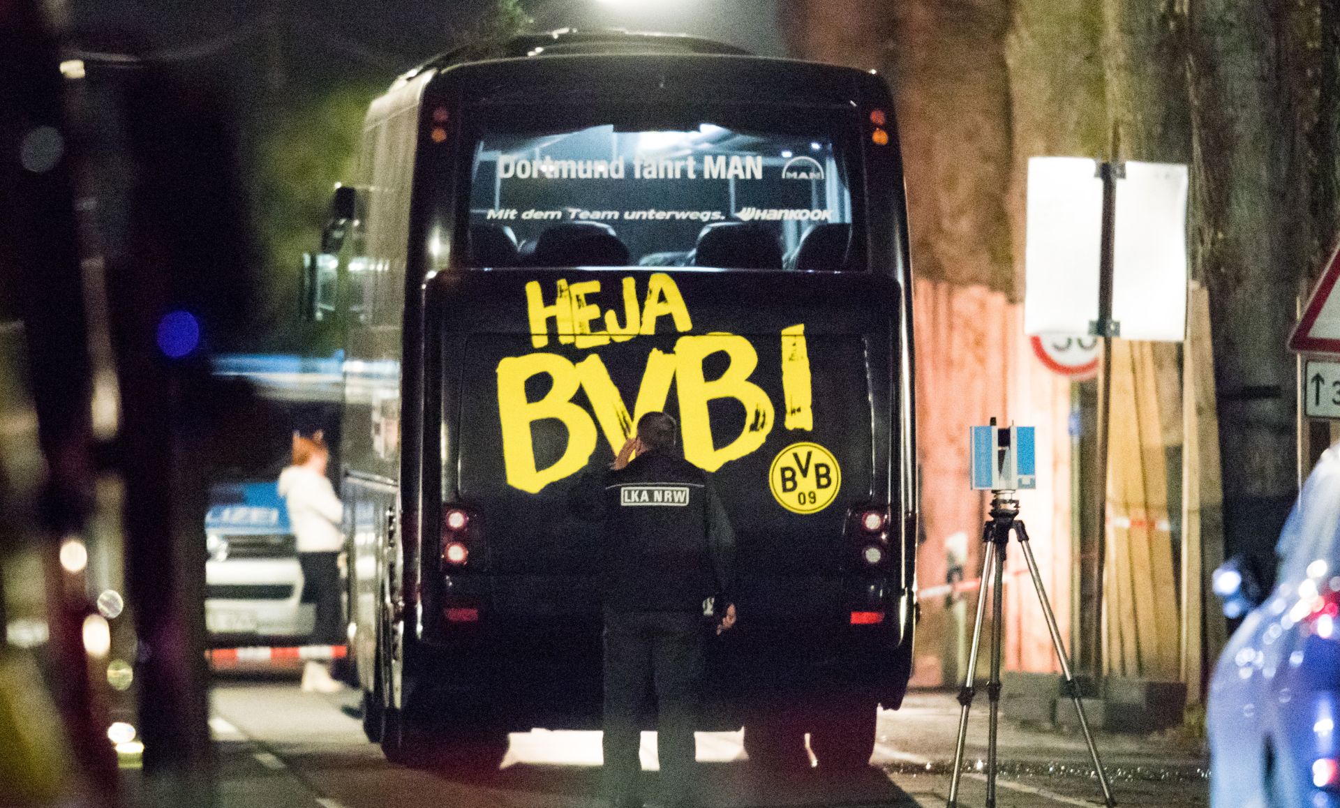 An officer of the State Office of Criminal Investigation examines the Borussia Dortmund team bus next to which three explosions occurred during the evening in Dortmund, Germany, 11 April 2017. The team was on its way to the Champions League match against AS Monaco. Dortmund's player Bartra was injured by the explosions. The match was cancelled. The background of the explosions is yet to be cleared. Photo: Marcel Kusch/dpa