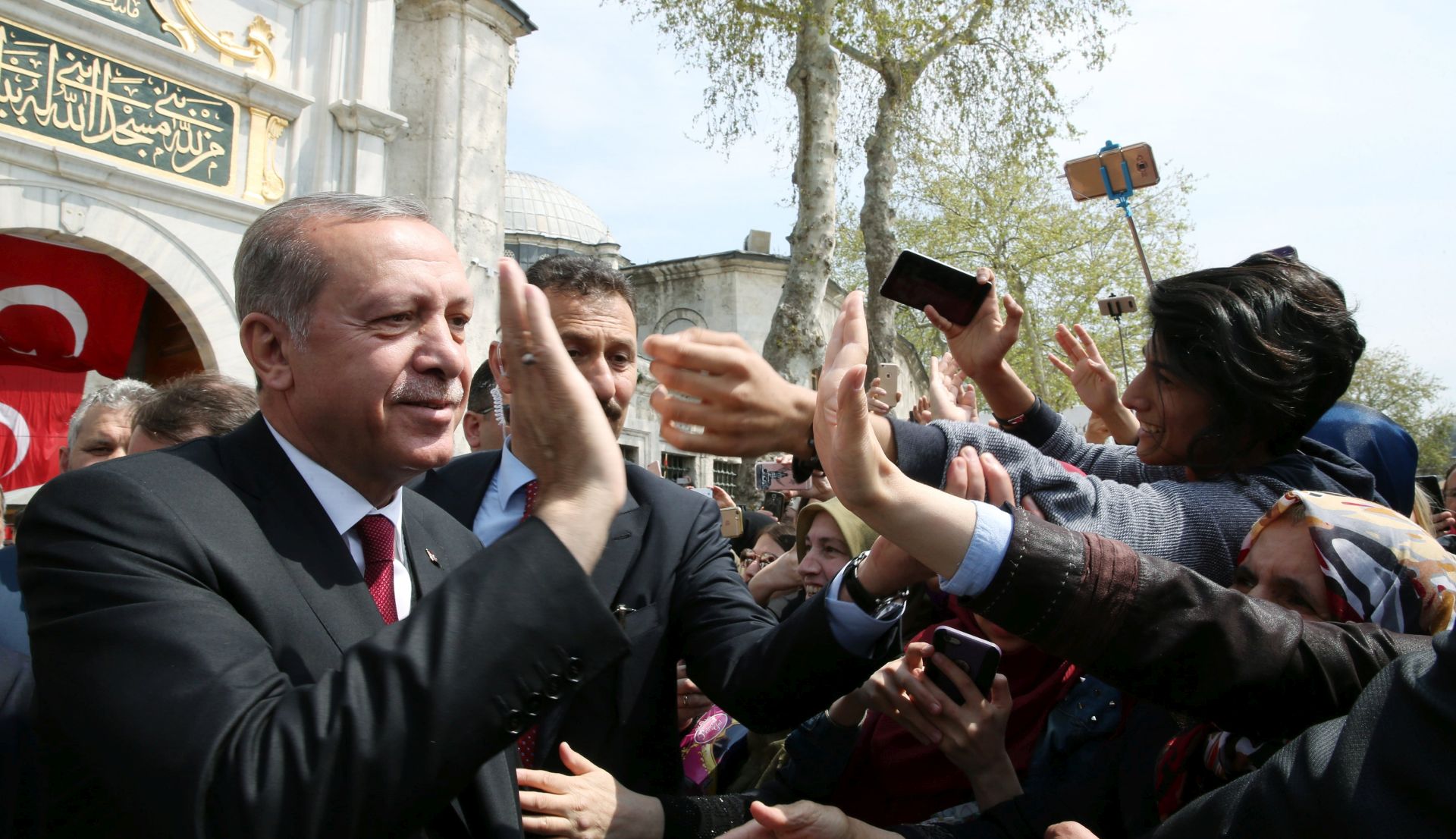 epa05912233 A handout photo made available by Turkish President Press office shows Turkish President Recep Tayyip Erdogan (L) greeting people after praying at Eyup Sultan mosque, Istanbul, Turkey, 17 April 2017. Media reports Turkish President Erdogan won a narrow lead of the 'Yes' vote in unofficial results, 17 April 2017. The proposed reform, passed by Turkish parliament on 21 January, would change the country's parliamentarian system of governance into a presidential one, which the opposition denounced as giving more power to Turkish President Erdogan.  EPA/TURKISH PRESIDENT PRESS OFFICE HANDOUT  HANDOUT EDITORIAL USE ONLY/NO SALES