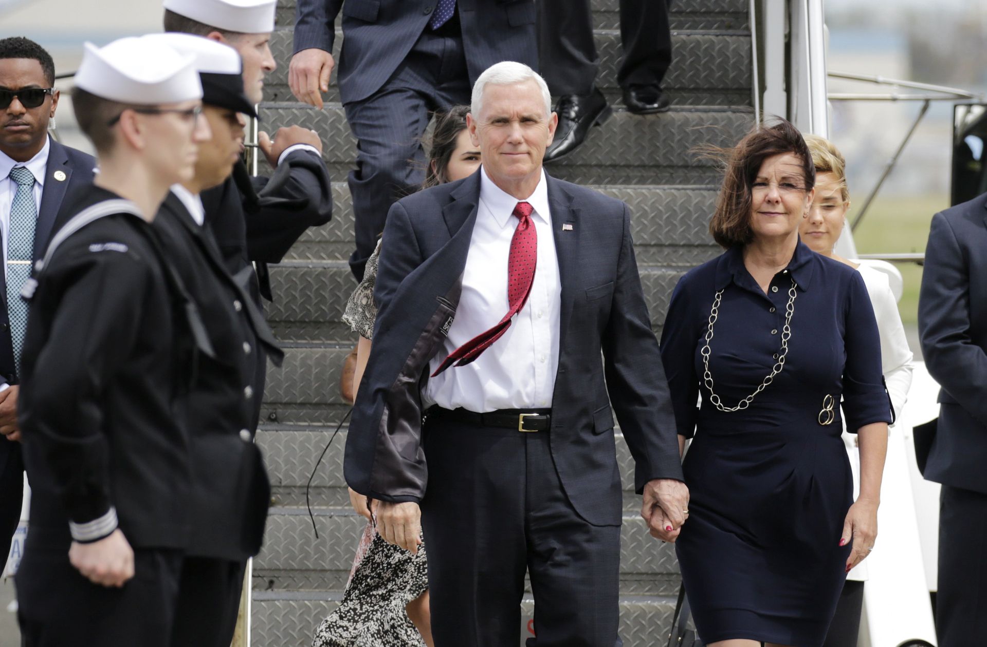 epa05912975 US Vice President Mike Pence (C) and his wife Karen Sue Pence (R) are welcomed by US Naval servicepersons upon their arrival at US Naval Air Facilities Atsugi in Ayase, Kanagawa Prefecture, southwest of Tokyo, Japan, 18 April 2017. Pence is on a tour of east Asia and will visit South Korea, Japan and China amid tensions over nuclear issues in the Korean Peninsula.  EPA/KIMIMASA MAYAMA