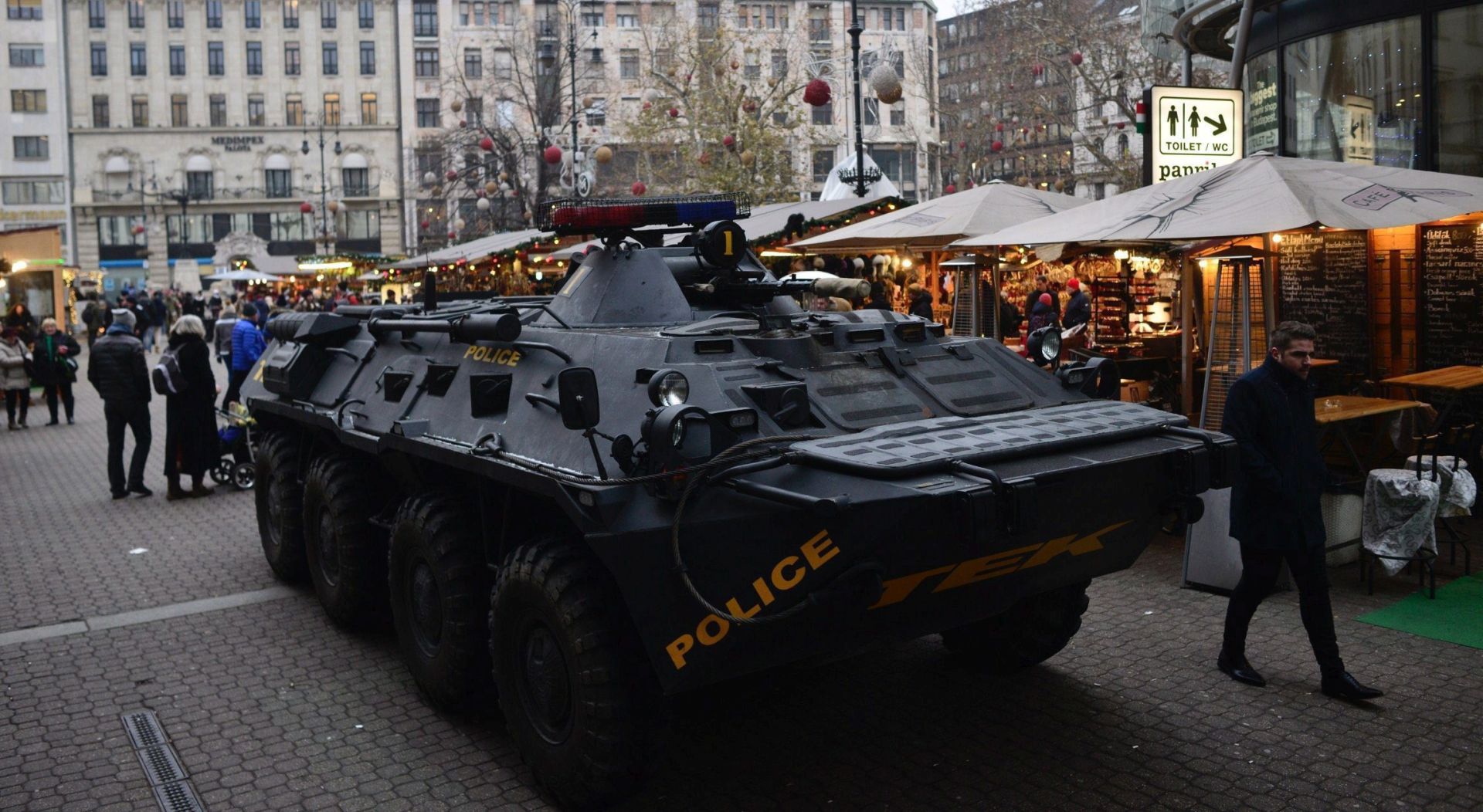 epa05683617 A passer-by walks past an armoured vehicle of the Counter Terrorism Centre of the Hungarian police standing guard at a Christmas market in downtown Budapest, Hungary, 20 December 2016. Security has been beefed up at venues visited by large number of people after at least 12 people were killed and dozens injured when a truck on 19 December drove into the Christmas market at Breitscheidplatz in Berlin, in what authorities believe was a deliberate attack.  EPA/Janos Marjai HUNGARY OUT