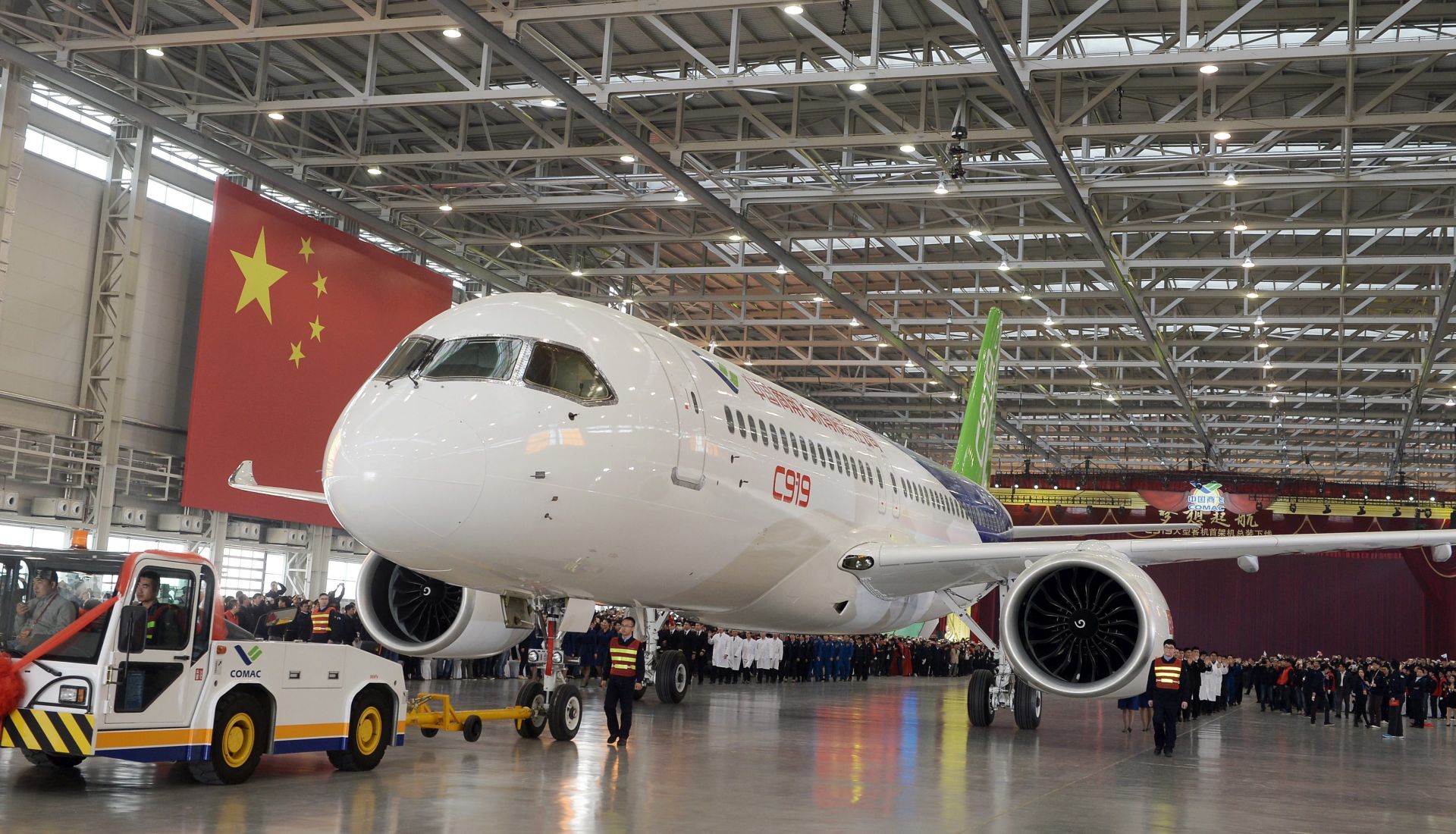 epa05007035 Workers roll out the first C919 passenger jet plane at the state-owned Commercial Aircraft Corporation of China Ltd (COMAC) in Shanghai, China 02 November 2015. China has spent seven years and huge amount to develop the 158-seat jet to boost its aviation industry, posing a challenge to Airbus and Boeing.  EPA/STRINGER CHINA OUT