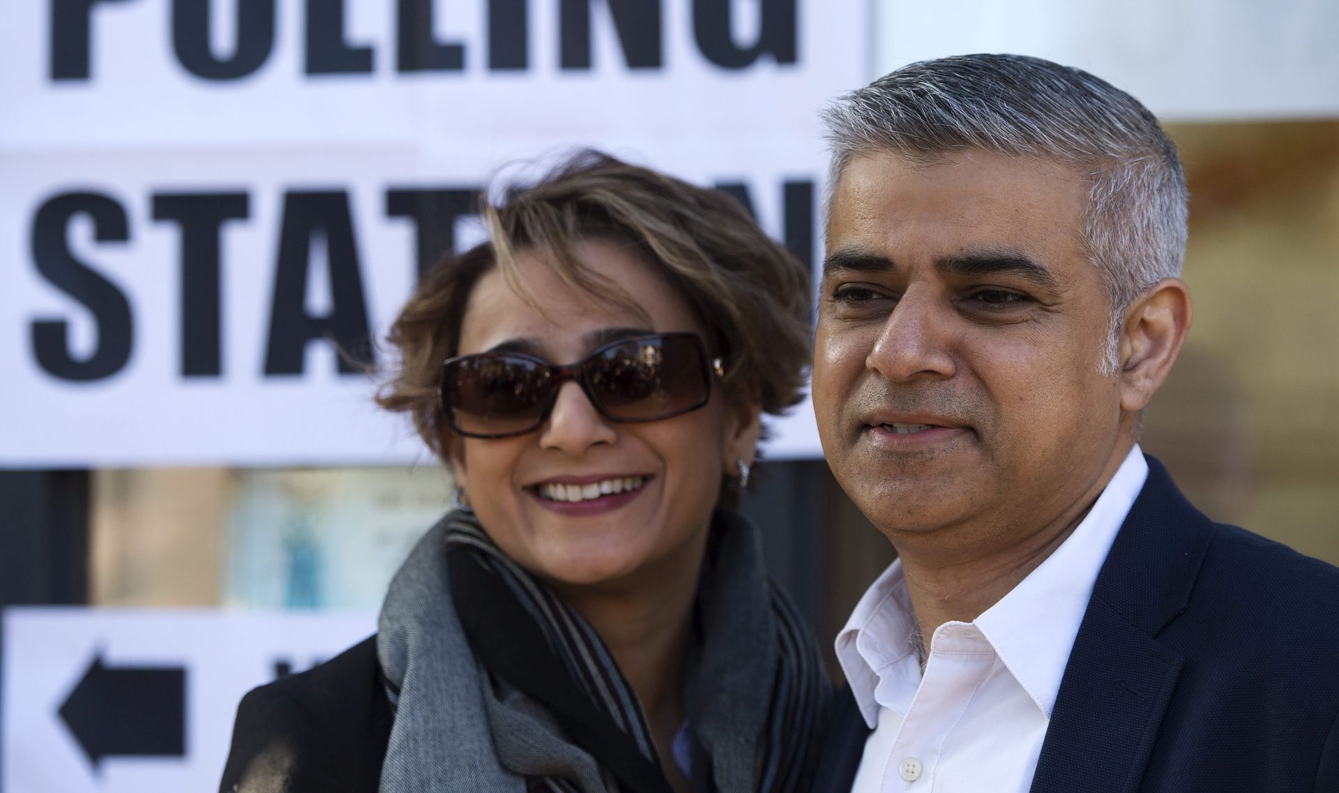 epa05290243 The Labour party candidate for Mayor of London Sadiq Khan (R) poses with his wife Saadiya Khan (L) after voting at a polling station in south London, Britain, 05 May 2016. Britons are voting in local elections across the UK today.  EPA/HANNAH MCKAY
