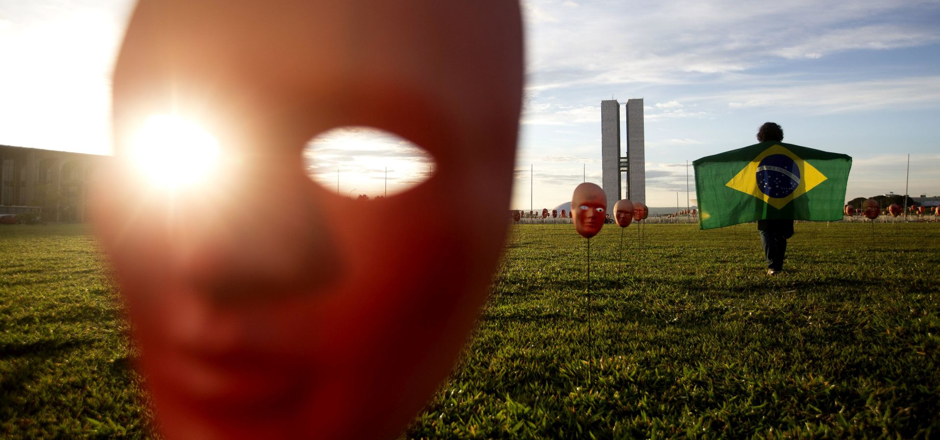 epa05984305 Members of Brazilia NGO 'Rio de la Paz' put masks on sticks representing the federal deputies, Senators and President Temer, outside the Brazilian Congress building in Brasilia, Brazil, 23 May 2017. Protestors deployed on the grass 595 white and red masks representing President Temer's Government members and as a protest against the corruption in it.  EPA/Joédson Alves