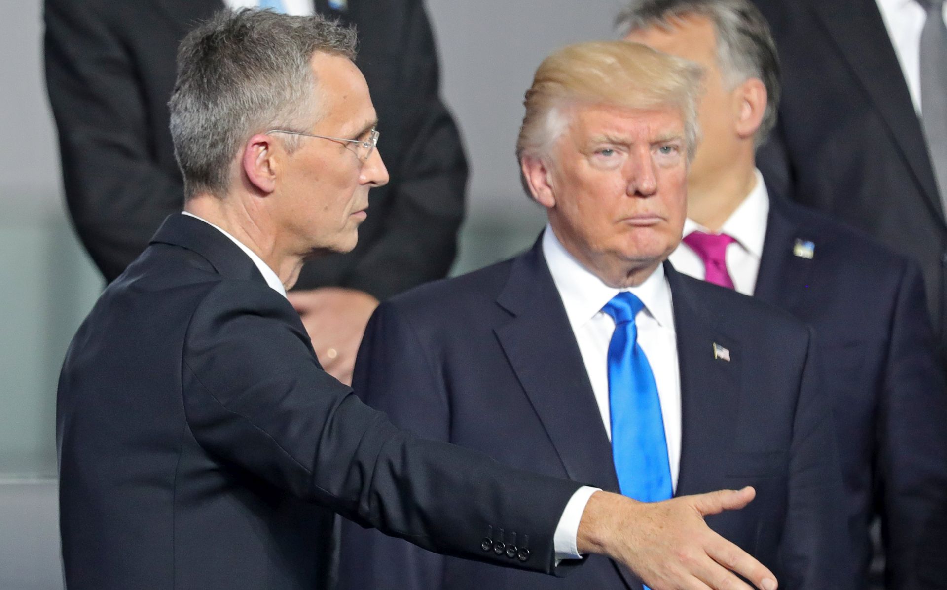 epa05989435 NATO Secretary General Jens Stoltenberg (L) and US President Donald J. Trump (R) arrive as they line up for the group photo at the NATO summit in Brussels, Belgium, 25 May 2017. NATO countries' heads of states and governments gather in Brussels for a one-day meeting.  EPA/ARMANDO BABANI
