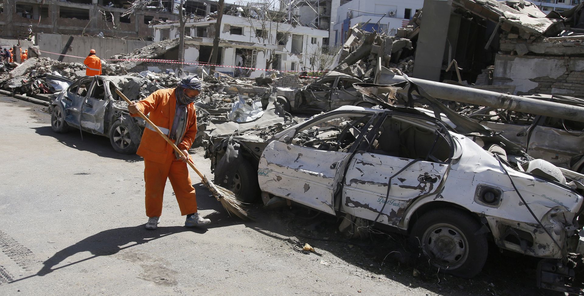 epa06001061 Afghan workers clean the scene of a suicide bomb attack nearby the German embassy in Kabul, Afghanistan, 31 May 2017. At least 80 people were killed and more than 350 wounded n a suicide bomb attack near the foreign embassies in Kabul.  EPA/JAWAD JALALI