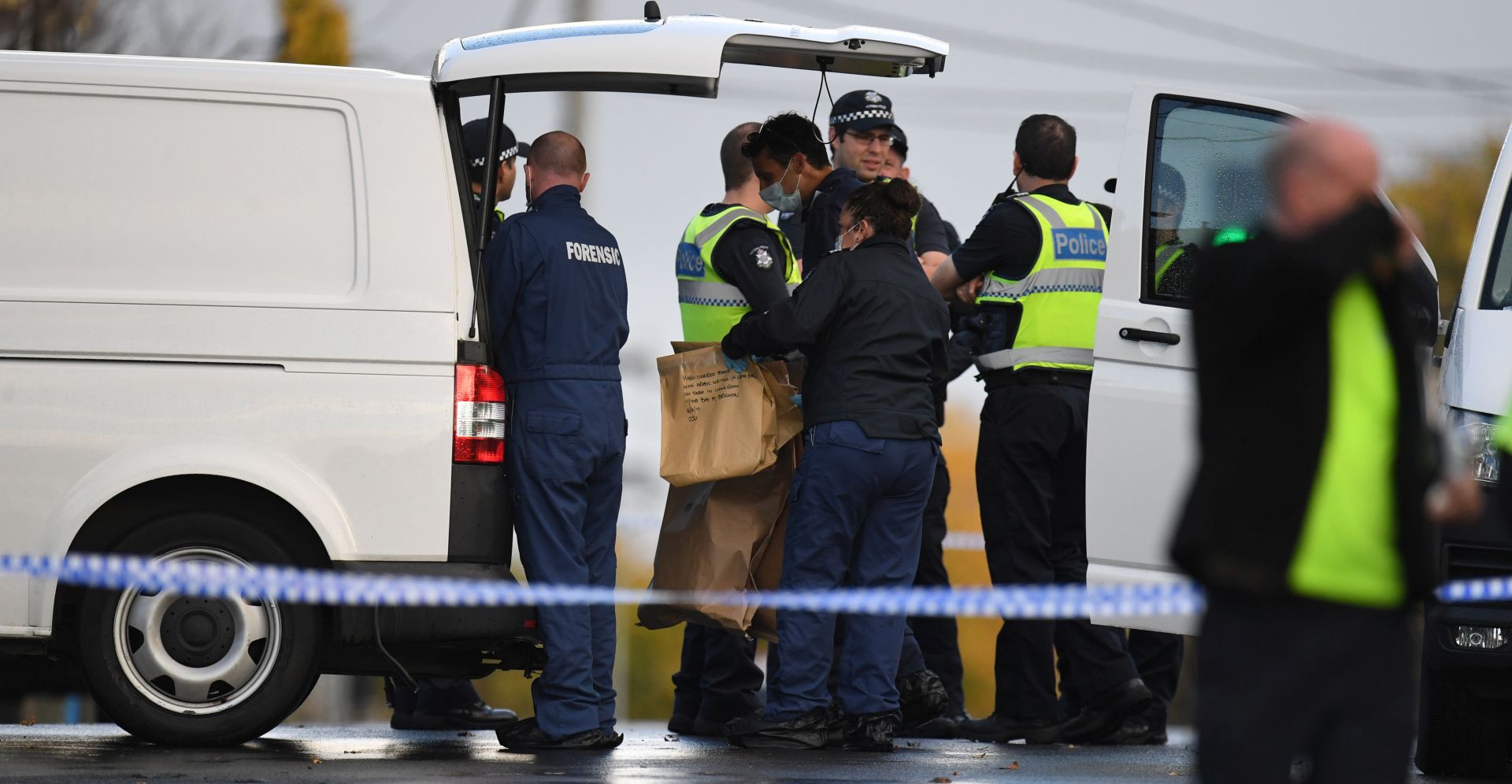 epa06012634 Forensic police hold an evidence bag which reads 'Hard covered book with Arabic writing' outside the Buckingham Serviced Apartments in Brighton in Melbourne, Australia, 06 June 2017. Victoria Police confirmed that the Melbourne siege, where a shootout left two men dead, three police officers injured, and a woman hostage rescued, is being treated as a terrorism related incident, after the so-called Islamic State (IS or ISIS, ISIL) claimed responsibility for the attack.  EPA/JULIAN SMITH  AUSTRALIA AND NEW ZEALAND OUT