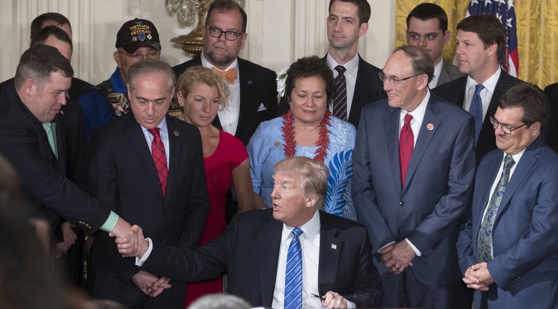 epa06046206 US President Donald J. Trump (C) shakes hands with retired US Army Sergeant Michael Verardo (L) beside Secretary of Veterans Affairs David Shulkin (2-L) at a signing ceremony for the Department of Veterans Affairs Accountability and Whistleblower Protection Act of 2017, in the East Room of the White House in Washington, DC, USA, 23 June 2017. The law is intended to raise the level of protection for whistleblowers in the Department of Veterans Affairs, in addition to making it easier to discipline and fire employees.  EPA/MICHAEL REYNOLDS