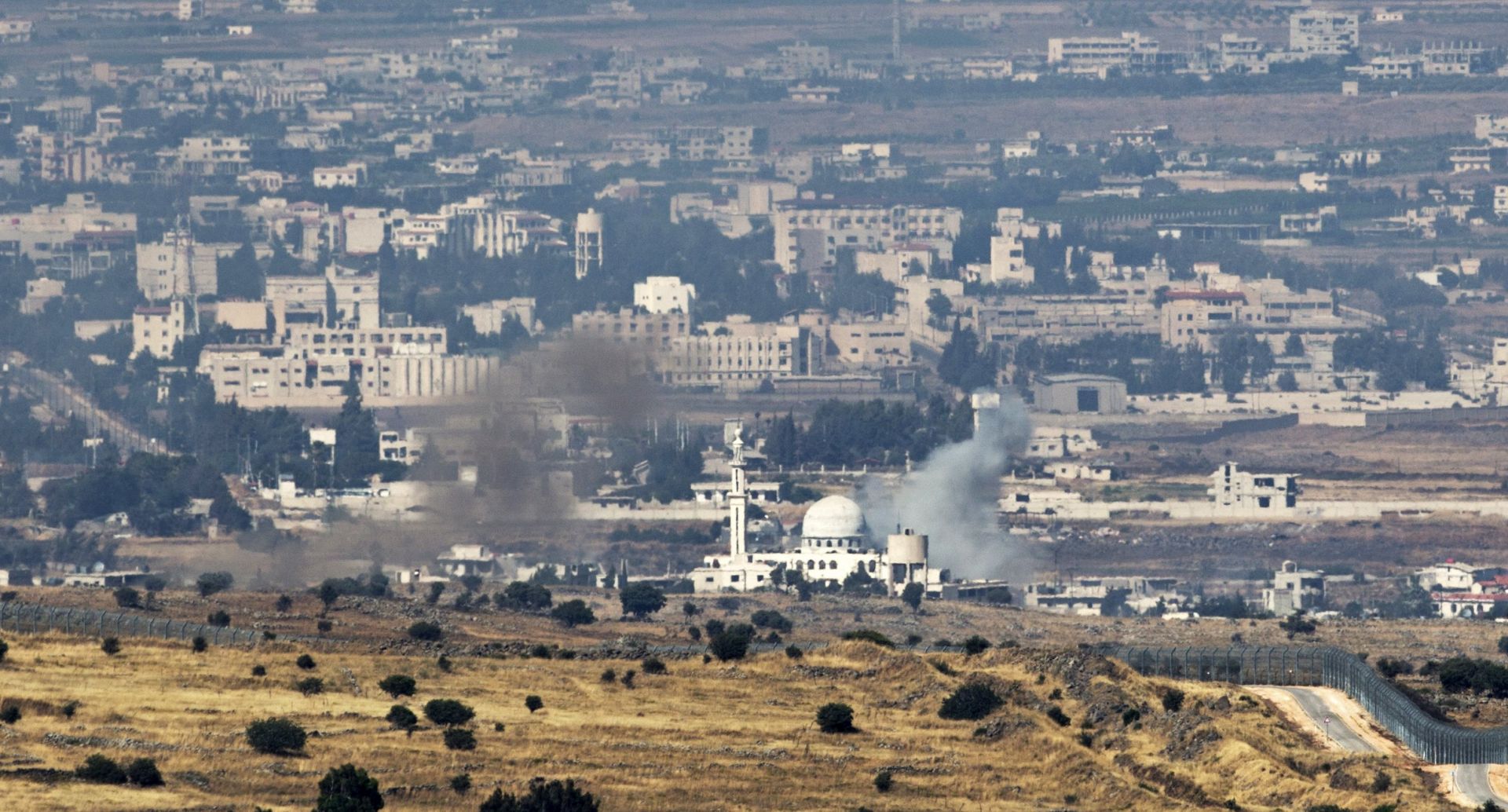 epa06047916 Smoke rise from Syrian village as a result of fighting near the city of Quneitra, in the Golan Heights, 24 June 2017. An Israeli army spokesman reported that in response to over ten projectiles launched from Syrian soil which hit Israel, Israeli aircraft targeted the position from which the launches originated and struck tanks belonging to the Syrian regime in the Northern Syrian Golan Heights. An official protest has been filed with United Nations Disengagement Observer Force (UNDOF).  EPA/ATEF SAFADI