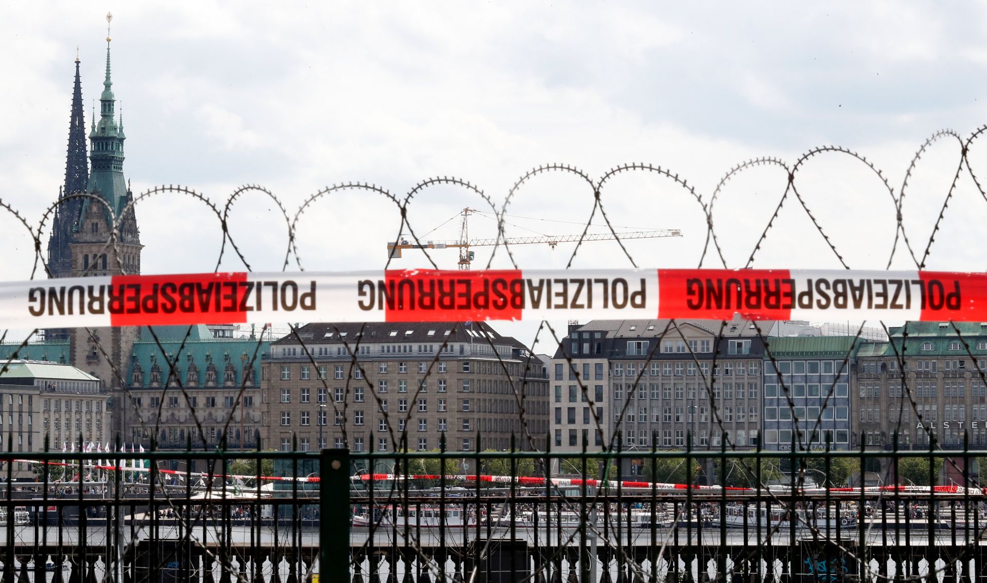 epa06063717 A barbed wire fence installed to prevent possible protesters to access a railway line is backdropped by the City Hall of Hamburg, northern Germany, 03 July 2017. The G20 Summit (or G-20 or Group of Twenty) is an international forum for governments from 20 major economies. The summit is taking place in Hamburg from 07 to 08 July 2017.  EPA/FRIEDEMANN VOGEL
