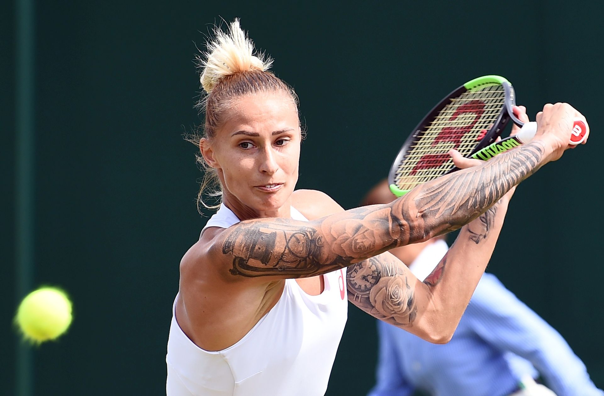 epa06065634 Polona Hercog of Slovenia returns to Annika Beck of Germany in their first round match during the Wimbledon Championships at the All England Lawn Tennis Club, in London, Britain, 04 July 2017.  EPA/GERRY PENNY EDITORIAL USE ONLY/NO COMMERCIAL SALES