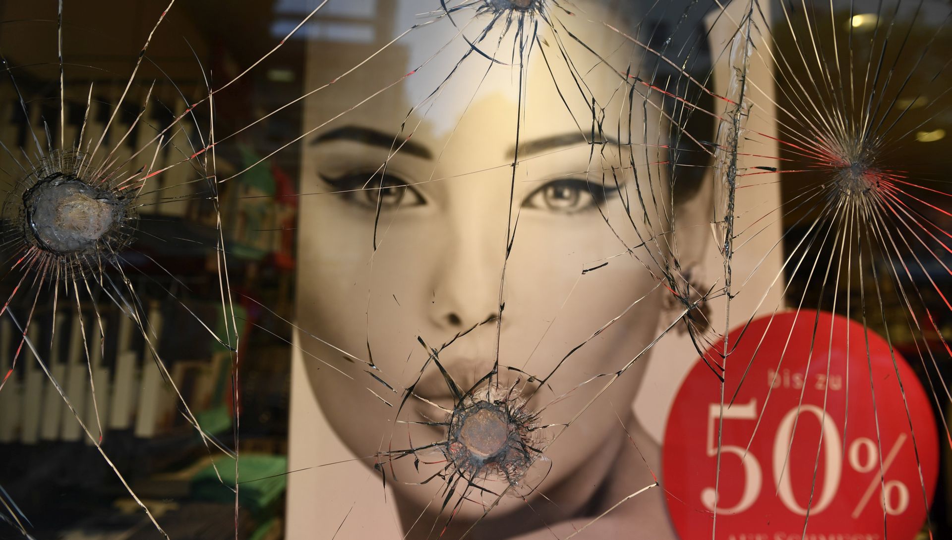 epa06071947 The display window of a fashion shop is severely damaged during the G20 summit in Hamburg, Germany, 07 July 2017. The G20 Summit (or G-20 or Group of Twenty) is an international forum for governments from 20 major economies. The summit is taking place in Hamburg from 07 to 08 July 2017.  EPA/FILIP SINGER