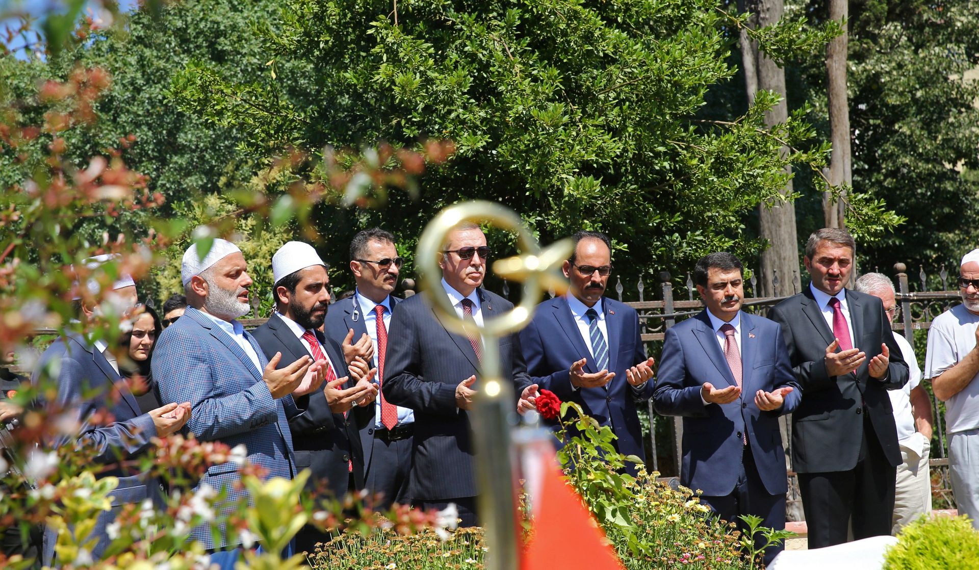 epa06081710 A handout photo made available by the Turkish President Press office shows, Turkish President Recep Tayyip Erdogan (C) visiting the graves of people killed during the 15 July 2016 coup attempt, in Istanbul, Turkey, 11 July 2017. The 15 July 2017 event marks the first anniversary of the failed coup attempt which led to some 50,000 workers being dismissed, some 8,000 people arrested, and scores of news outlets shut down by the government. Turkish President Recep Tayyip Erdogan blamed US-based Turkish cleric Fetullah Gulen and his movement for masterminding the failed coup and Turkey remains under a state of emergency as a result.  EPA/HANDOUT  HANDOUT EDITORIAL USE ONLY/NO SALES
