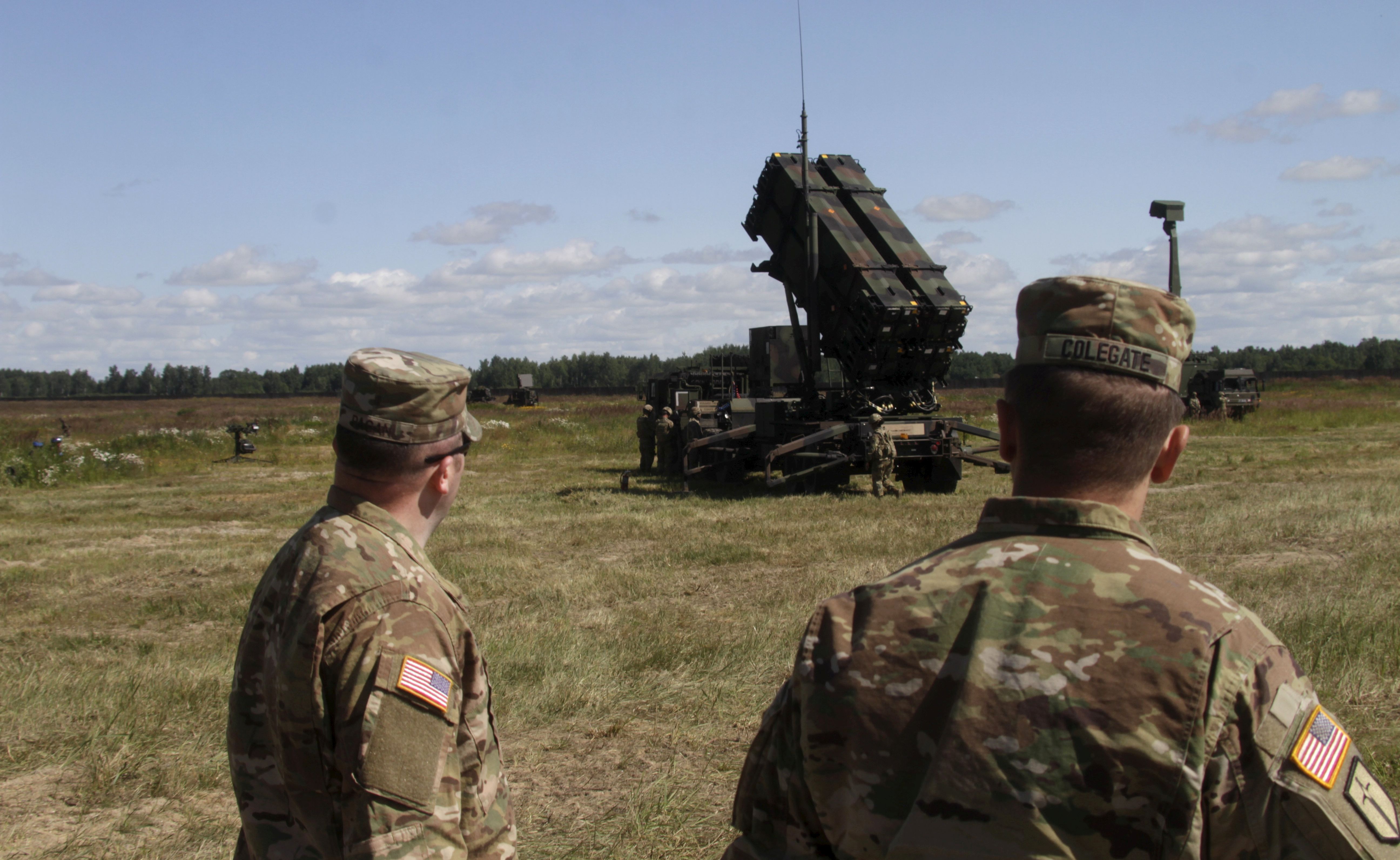 epa06098544 US soldiers stand behind an US surface-to-air missile system 'Patriot' launcher during the air defence exercise 'Tobruq Legacy 2017' at the Sauliai Air base, Lithuania, 20 July 2017. The exercise, which according to AIRCOM, the Allied Air Command of the North Atlantic Treaty Organization (NATO), continues until 22 July mainly aims at serving 'not only as validation of newly obtained capabilities, but provides an opportunity to improve the level of interoperability of multinational Surface-Based Air and Missile Defence systems forces' as said on the AIRCOM's website.  EPA/VALDA KALNINA