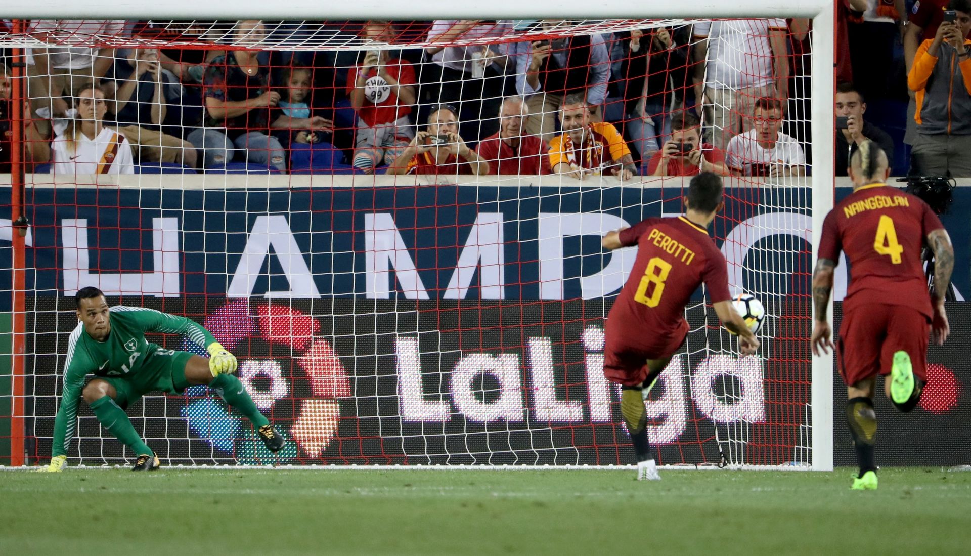 epa06109750 Diego Perotti (C) of AS Roma scores a penalty shot past goalkeeper Michael Vorm (L) of Tottenham Hotspur during their match of the International Champions Cup at Red Bull Arena in Harrison, New Jersey USA, 25 July 2017.  EPA/ANDREW GOMBERT