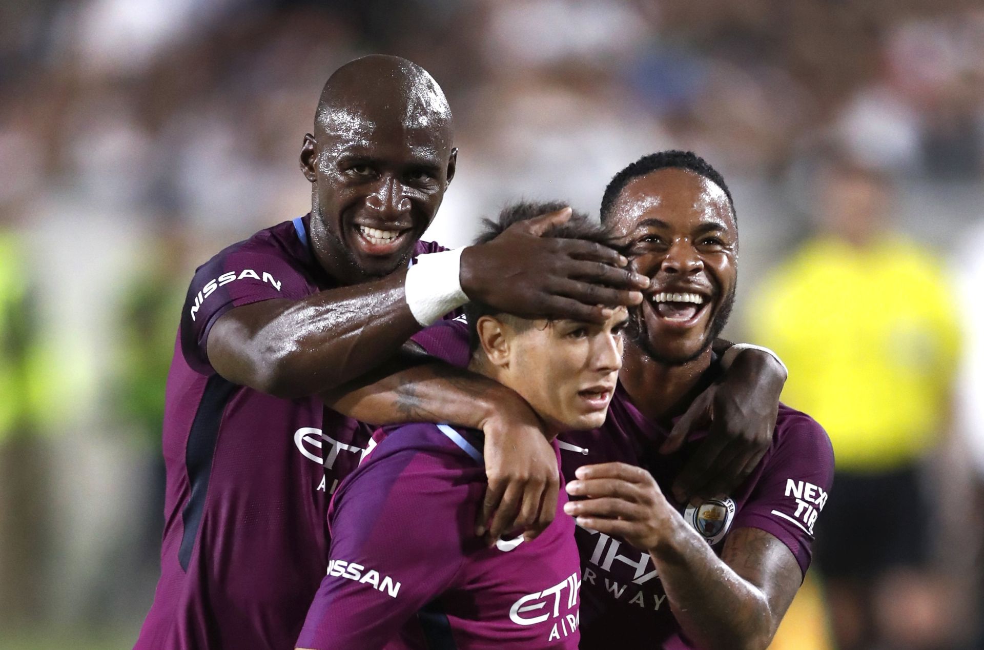 epa06111924 Manchester City's Brahim Diaz (C) is embraced by teammates Eliaquim Mangala (L) and Raheem Sterling (R) after Diaz scored a goal against the Real Madrid CF in second half action of their International Champions Cup soccer match at the Los Angeles Memorial Coliseum in Los Angeles, California, USA, 26 July 2017. Manchester City won the match.  EPA/PAUL BUCK
