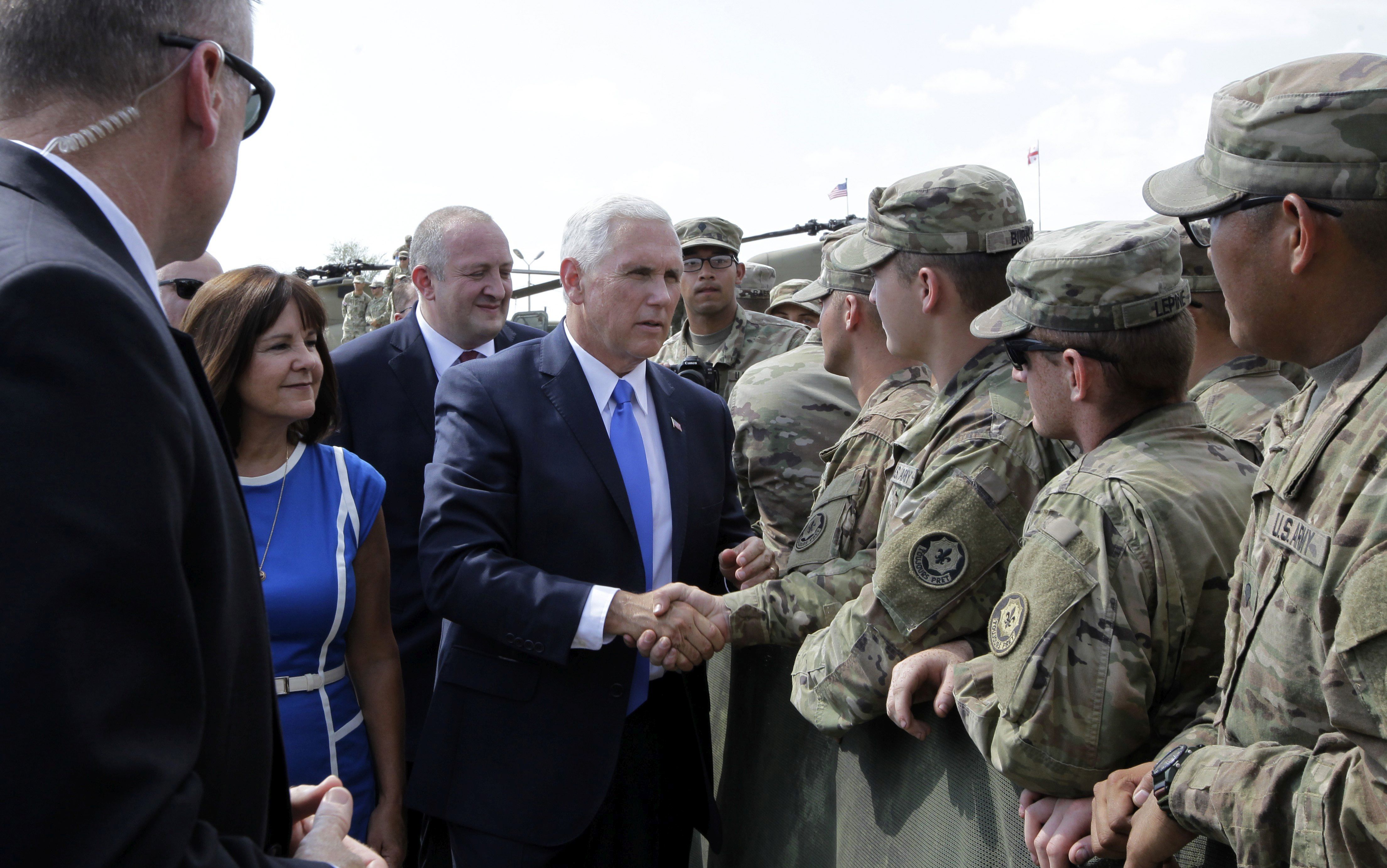 epa06119924 US Vice President Mike Pence (C) and his wife Karen Pence (2-L) greet servicemen participating in the Noble Partner 2017 joint multinational military exercises outside Tbilisi, Georgia, 01 August 2017.  EPA/SHAKH AIVAZOV/POOL