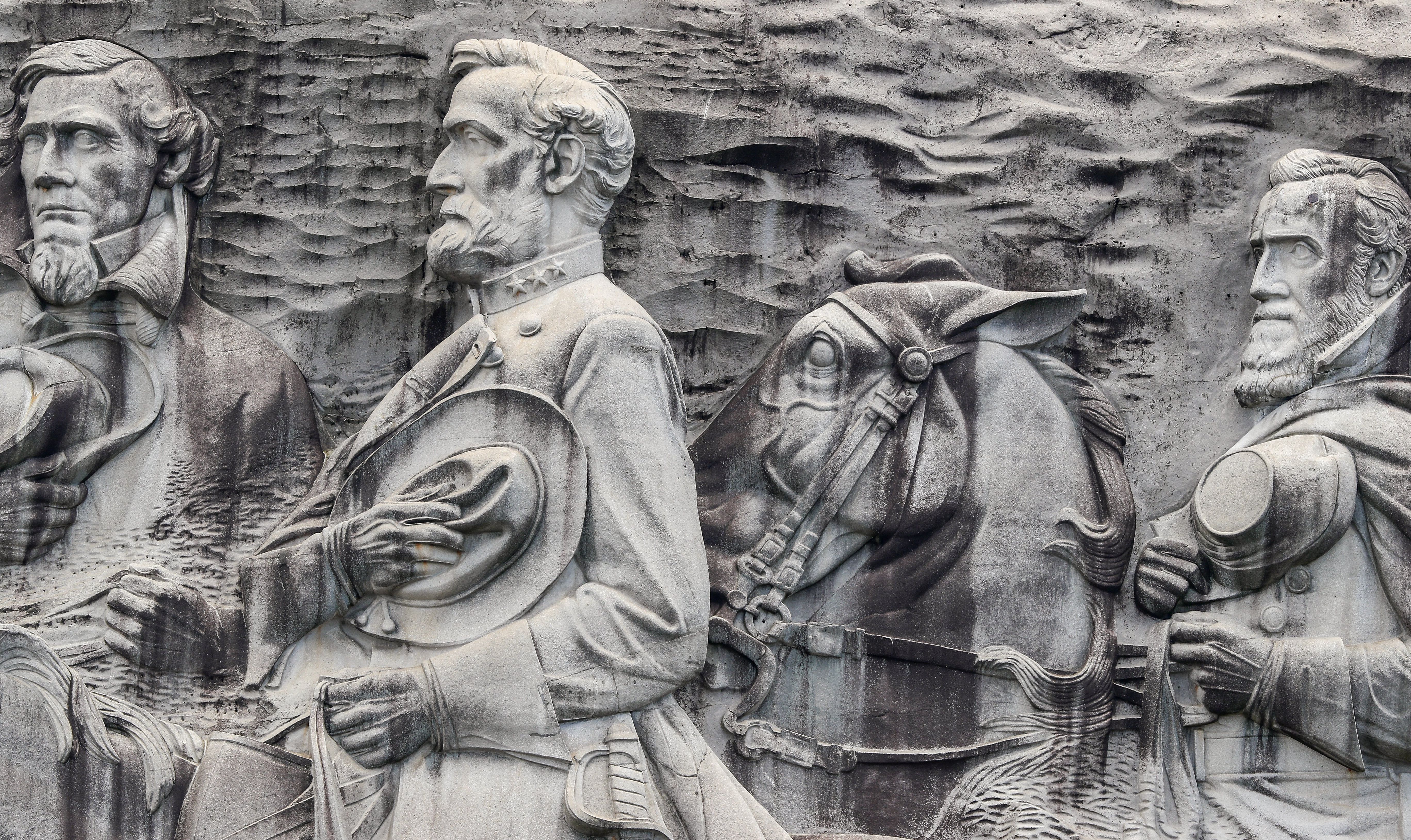 epa06150541 The Confederate Memorial Carving, depicting three Confederate figures of the US Civil War, President Jefferson Davis (L), General Robert E. Lee (C) and Thomas J. 'Stonewall' Jackson (R), on Stone Mountain in Stone Mountain, Georgia, USA, 18 August 2017. Activists have renewed calls for the removal of Confederate and US Civil War memorials after the violence in Charlottesville, Virginia, including Georgia Democratic gubernatorial candidate Stacy Abrams.  EPA/ERIK S. LESSER
