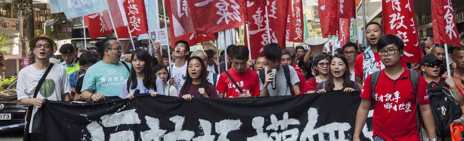 epa06152785 Students lead Hong Kong people with a Chinese banner that reads 'Protesting Authoritarianism is not a Crime' as they march through the streets in support of imprisoned student political activists Joshua Wong, Nathan Law and Alex Chow, Hong Kong, China, 20 August 2017. On 17 August the Court of Appeal sentenced Joshua Wong, Alex Chow Yong-kang and Nathan Law Kwun-chung to six, seven and eight months in jail respectively for unlawful assembly on the first day of the Occupy Central Umbrella Movement when they stormed the Civic Square outside the Hong Kong government headquarters on September 2014.  EPA/ALEX HOFFORD