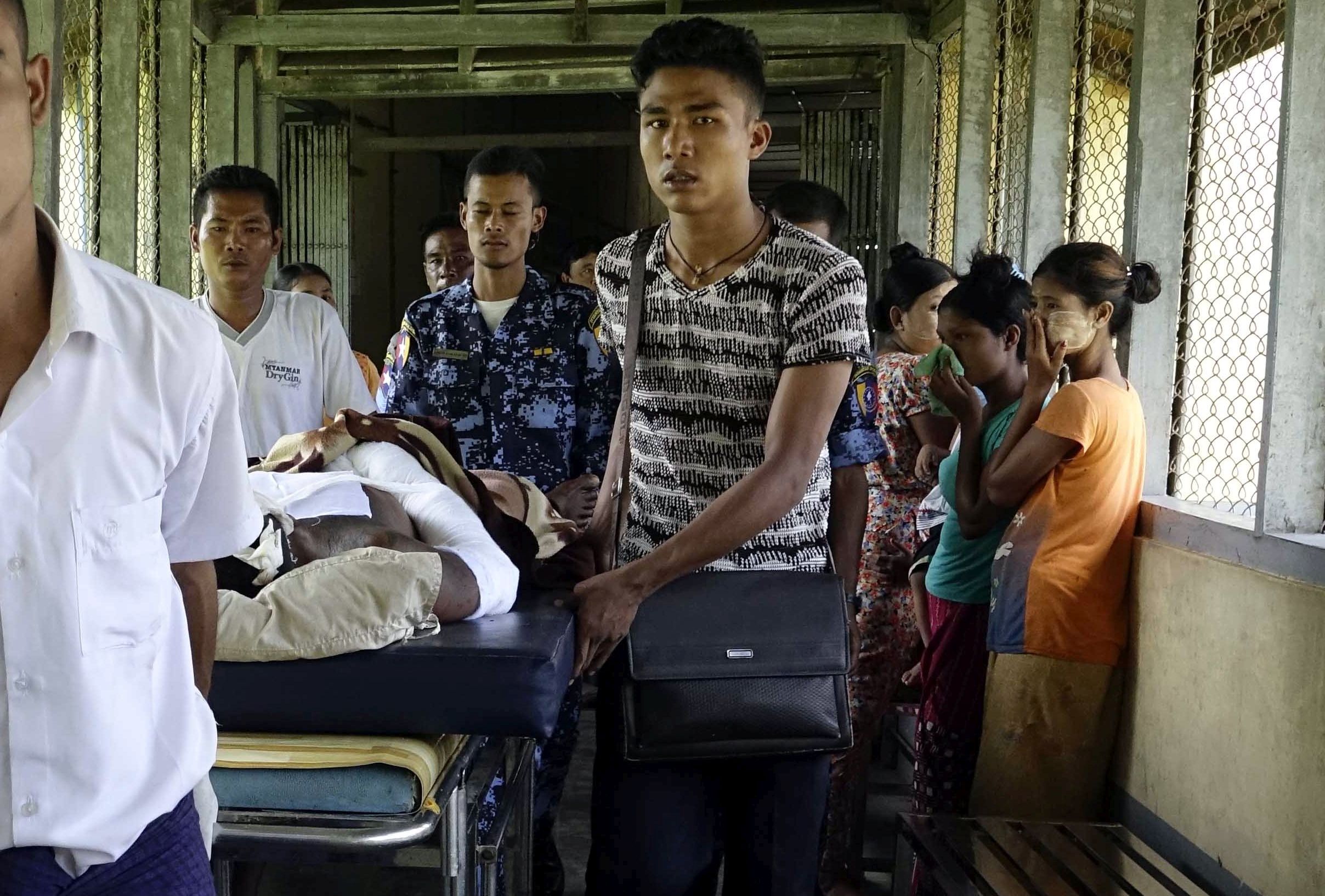 epa06169668 An injured Myanmar police officer (C-R) arrives to the Sittwe hospital, Sittwe, Rakhine State, western Myanmar, 29 August 2017. According to a statement by the Myanmar State Counselor Office Information Committee, a group of eleven law enforcement officials, one government staff, eleven civilians and about 80 militants from the Arakan Rohingya Salvation Army (ARSA) terrorist group were killed during fighting between 25 to 27 August 2017 in Myanmar after ARSA fighters attacked police outposts and an army base in the western state of Rakhine. The Central Committee for Counter Terrorism of Myanmar had declared ARSA a terrorist group on 25 August.  EPA/NYUNT WIN