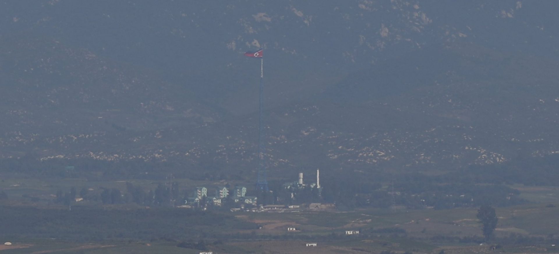 epa06205519 A view of North Korean flag in Gijang-gun county on the North Korean side of the Military Demarcation Line in the Demilitarized Zone (DMZ) seen from the Odusan observatory in Paju, in Gyeonggi-do, South Korea, 15 September 2017.  EPA/JEON HEON-KYUN