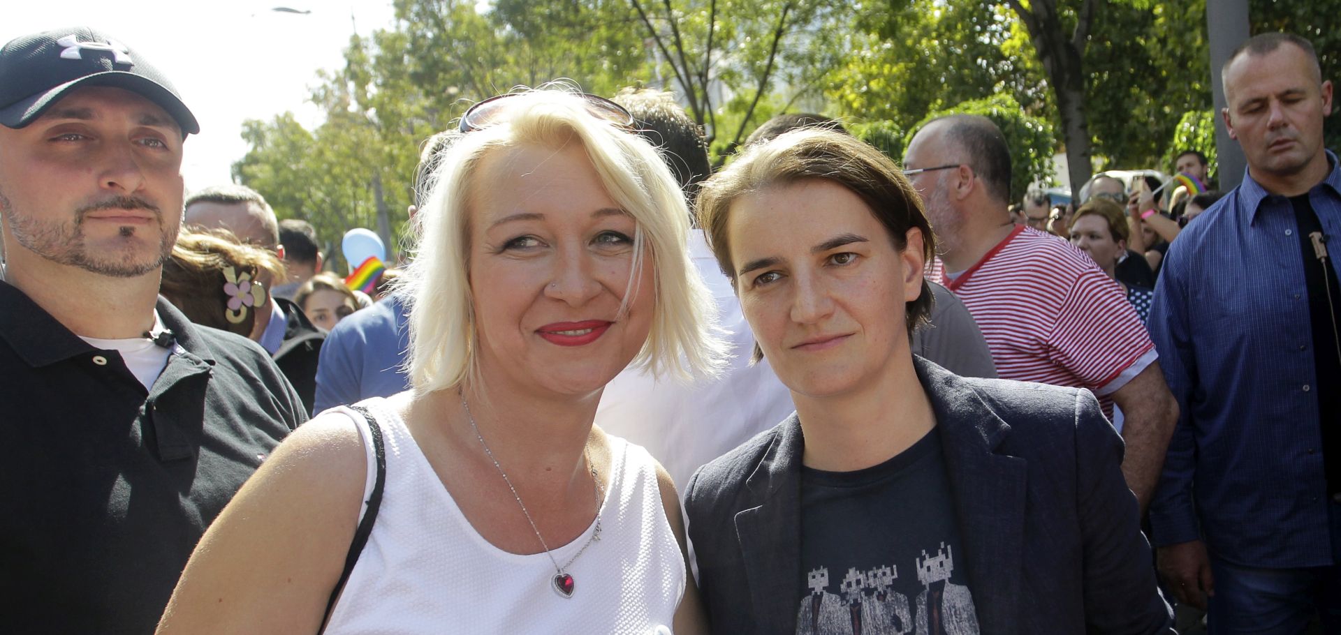 epa06210023 Serbian Prime Minister Ana Brnabic (C-R) poses for a photo with Helena Vukovic (C-L), a transgender former Serbian Army officer, at the Belgrade Pride Parade march in Belgrade, Serbia, 17 September 2017. Others are not identified. Holding rainbow colored flags, balloons and banners with slogans such as 'For change' pride participants marched through the main streets of Serbia's capital in a rally supported by ILGA-Europe - the European Region of the International Lesbian, Gay, Bisexual, Trans and Intersex Association (ILGA).  EPA/ANDREJ CUKIC