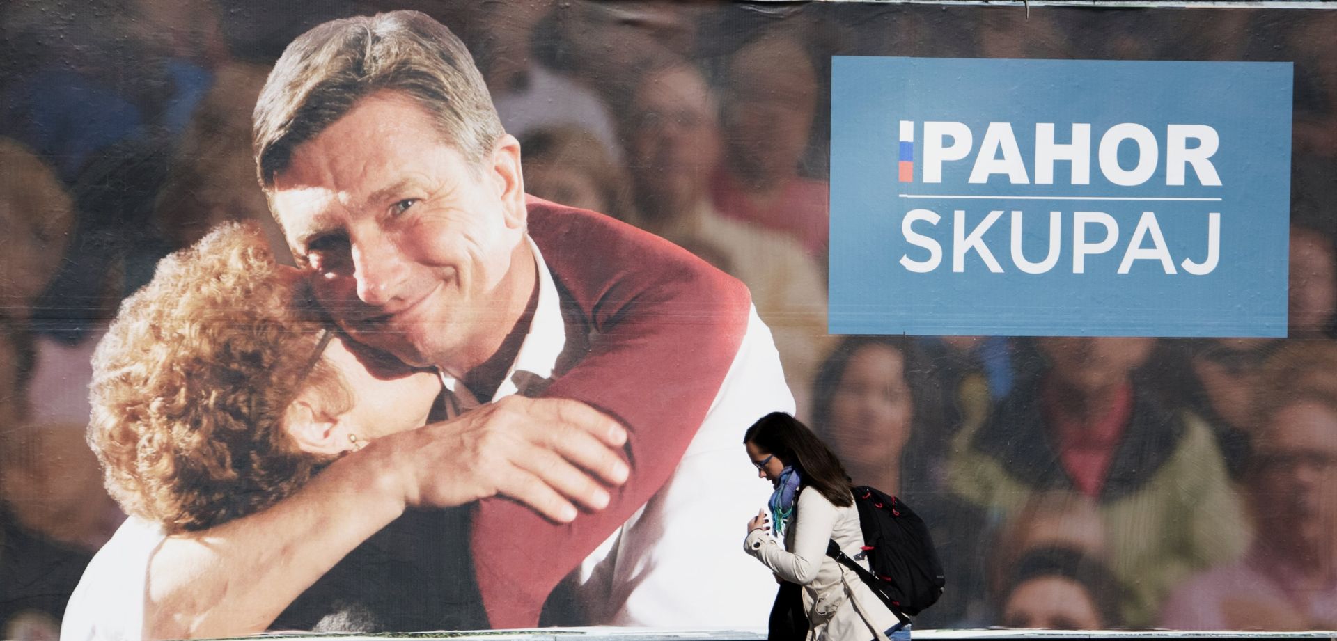 epa06273123 A person on rollerblades passes an election poster showing Borut Pahor, current President of Slovenia and Independent candidate for the Slovenian Presidential Elections 2017, in Ljubljana, Slovenia, 18 October 2017. The Slovenian Presidential Elections take place in Slovenia on 22 October 2017.  EPA/IGOR KUPLJENIK