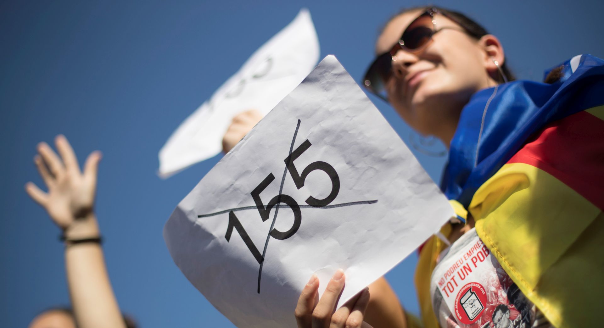 epa06290581 A participant shows a sign with the number 155 crossed out, during a protest of Catalan university and secondary students against the application of the Spanish Constitution's Article 155 to the Catalonia Region, in Barcelona, northeastern Spain, 26 October 2017. The students marched downtown Barcelona to ask for the release of the presidents of the Catalan National Assembly (ANC) and Omniun, Jordi Sanchez and Jordi Cuixart, as well as the proclamation of the independence in Catalonia. Meanwhile, Catalan President, Carles Puigdemont, is expected to give an inminent press conference to announce whether he calls for early elections in Catalonia or establishes the unilateral declaration of independence.  EPA/MARTA PEREZ