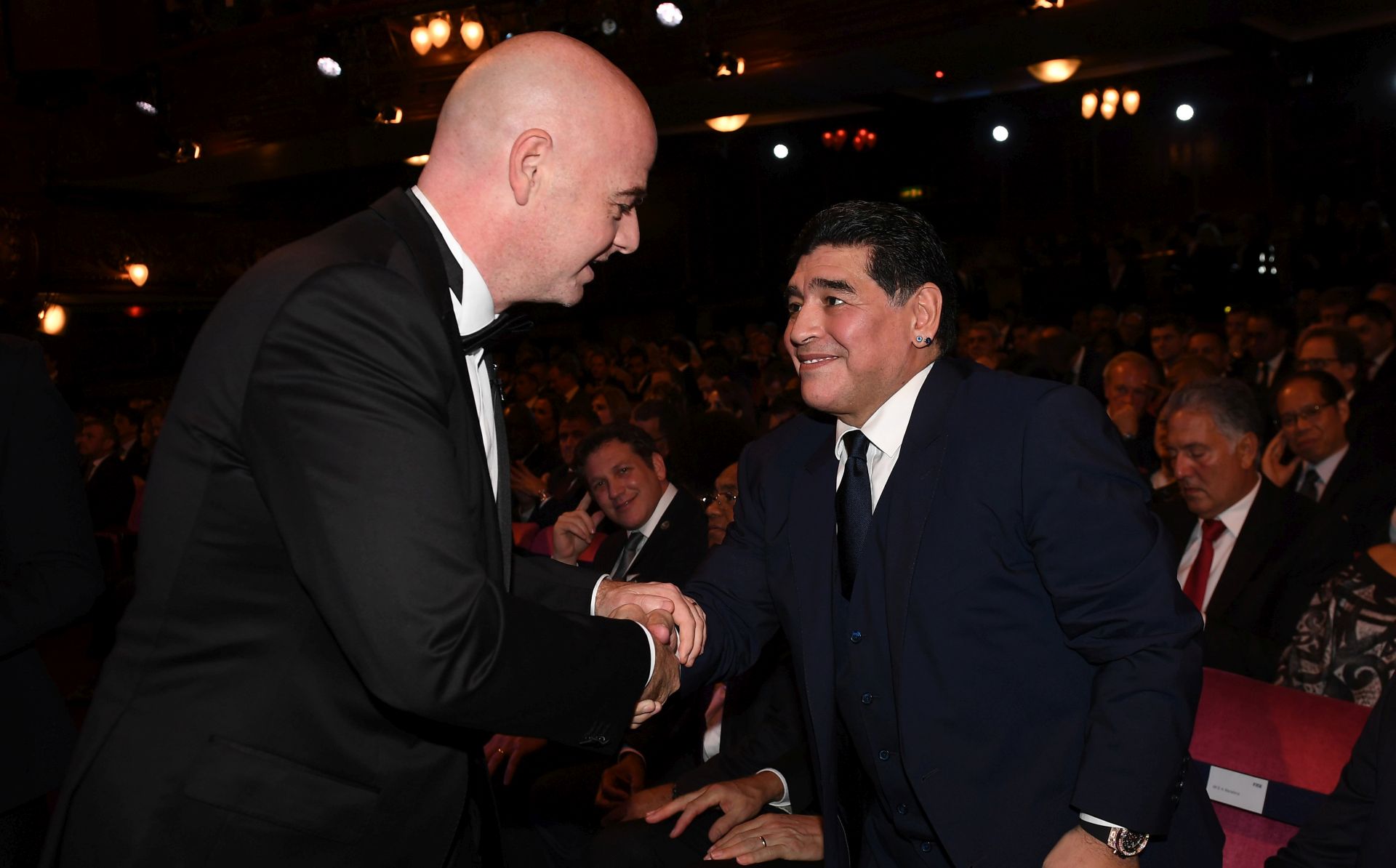 epa06284967 FIFA president Gianni Infantino (L) greets Argentine soccer legend Diego Maradona during the Best FIFA Football Awards 2017 at the London Palladium, London, Britain 23 October 2017.  EPA/ANDY RAIN