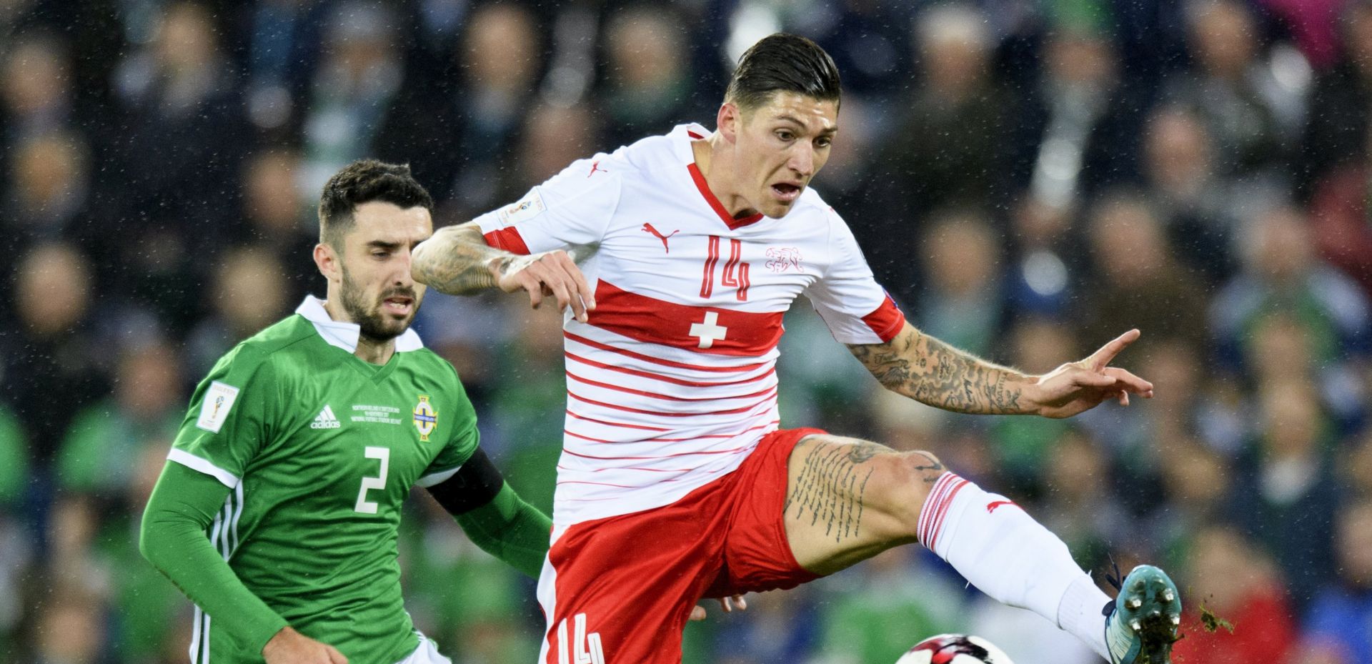 epa06318939 Northern Ireland's defender Conor McLaughlin, left, fights for the ball with Switzerland's midfielder Steven Zuber, right, during the 2018 Fifa World Cup play-offs first leg soccer match Northern Ireland against Switzerland at Windsor Park, in Belfast, Northern Ireland, Britain, Thursday, November 9, 2017.  EPA/LAURENT GILLIERON