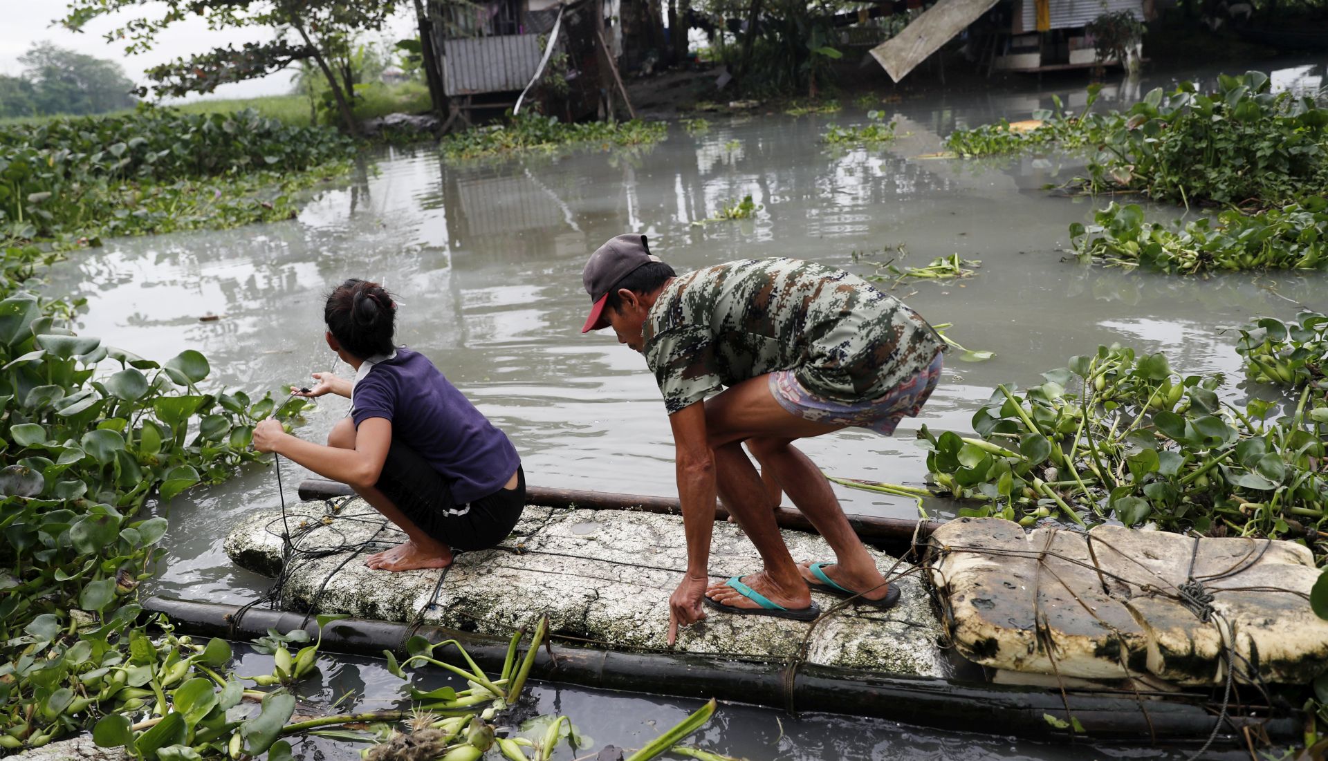 epa06401049 Filipinos on makeshift raft wade on floodwater in Taguig city, south of Manila, Philippines, 21 December 2017. State weather bureau, the Philippine Atmospheric Geophysical and Astronomical Services Administration (PAGASA) raised storm signals over Mindanao provinces as tropical storm Tembin expected to landfall. The National Disaster Risk Reduction Management Council (NDRRMC) warned travelers for Chistmas holidays to monitor advisories on the possible cancellation of trips, to avoid the influx of passengers.  EPA/FRANCIS R. MALASIG