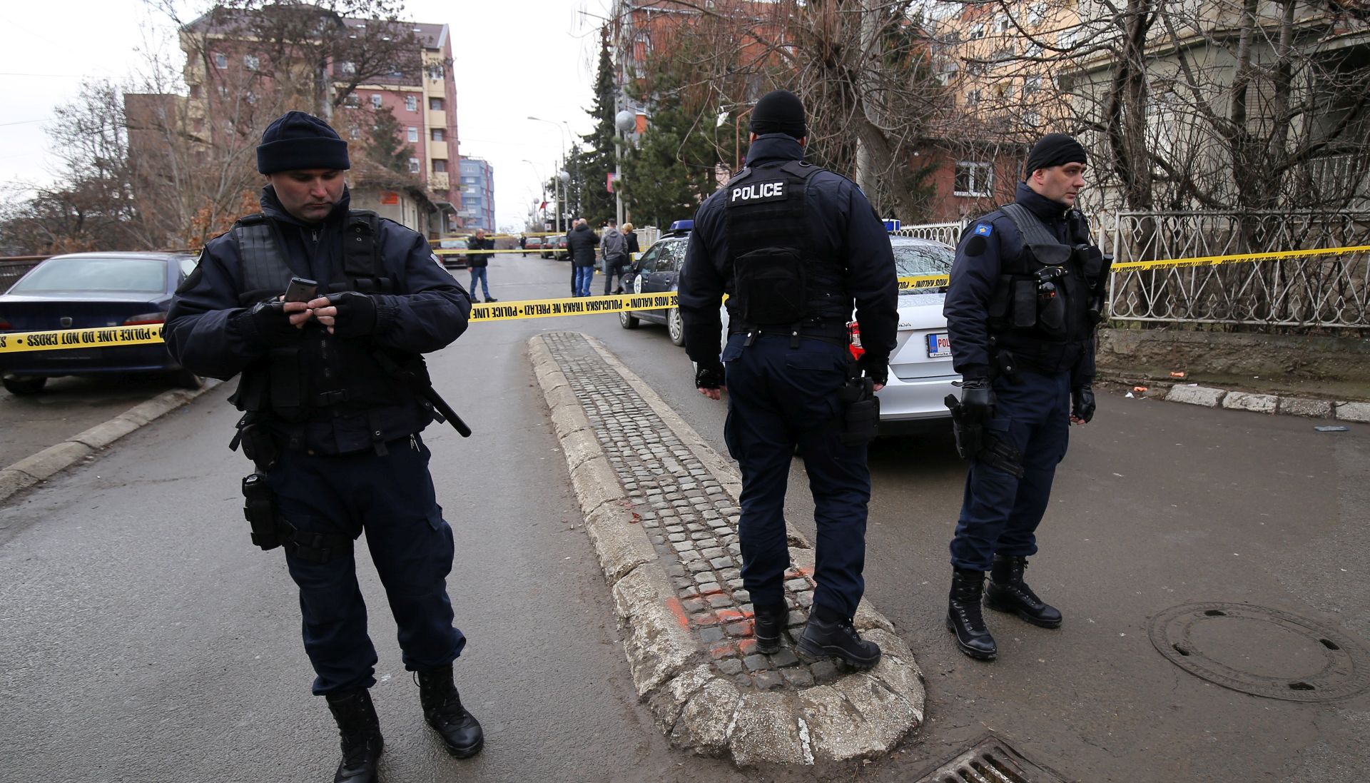 epa06443095 Police guards at the sealed-off crime scene where Oliver Ivanovic, the former State Secretary for Kosovo and Metohija and a subject of a controversial war crimes trial and retrial, was shot in Mitrovica, Serbia, 16 January 2018. The prominent Ivanovic was shot in front of his office in Mitrovica, Kosovo, 16 January 2018, according to media reports.  EPA/STRINGER