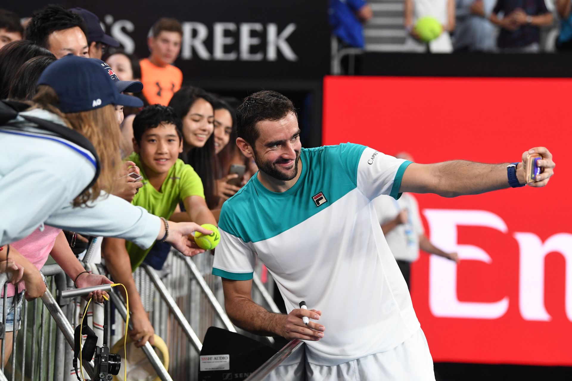 epa06453523 Marin Cilic of Croatia signs autographs after his win against Ryan Harrison of the United States at the Australian Open tennis tournament in Melbourne, Victoria, Australia, 19 January 2018.  EPA/JOE CASTRO  AUSTRALIA AND NEW ZEALAND OUT