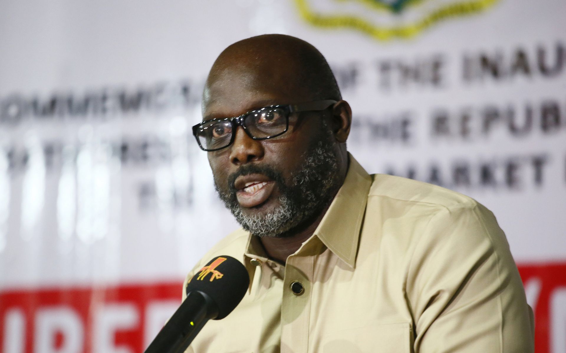 epa06455126 Liberia's president elect, George Weah(L), speaks during an exhibition of Liberian made products at the Liberia Market place, Nancy B. Doe Market in Monrovia, as part of events marking his official inauguration ceremony in Monrovia, Liberia, 19 January 2018. Weah will be sworn in as president on 22 January, to succeed incumbent president, and Africa's first female democratically elected president, Sirleaf, who concludes her second and final term in office.  EPA/AHMED JALLANZO