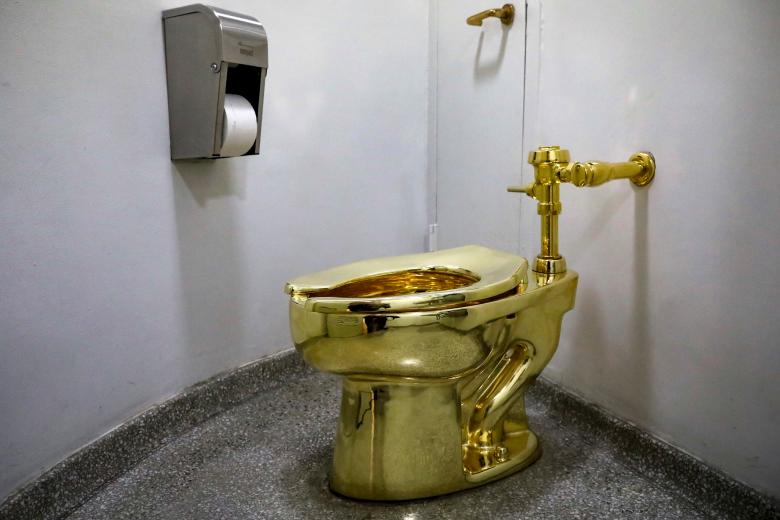 "America," a fully functional solid gold toilet by Italian artist Maurizio Cattelan, is seen at The Guggenheim Museum in New York City. REUTERS/Brendan McDermid
