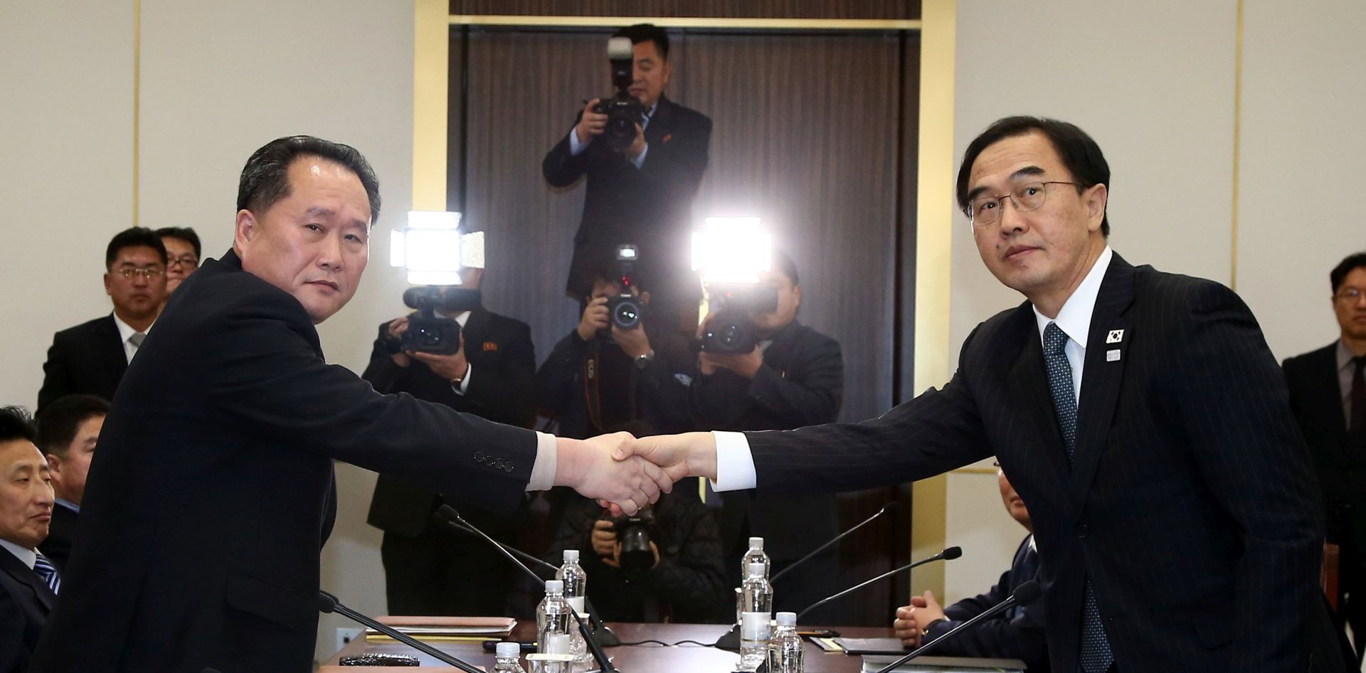 epa06426741 South Korean Unification Minister and chief delegate Cho Myoung-gyon (R) shakes hands with North Korea's chief delegate Ri Son-gwon (L) after their meeting in the truce village of Panminjom, in Paju, South Korea, 09 January 2018. North Korea agreed to send a delegation to the 2018 Winter Olympic Games, which will be hosted in February in South Korea. The South also proposed family reunions, for those who were separated during the Korean War, to take place during the Lunar New Year holiday, which falls in the same period of the Winter Olympics.  EPA/KOREA POOL